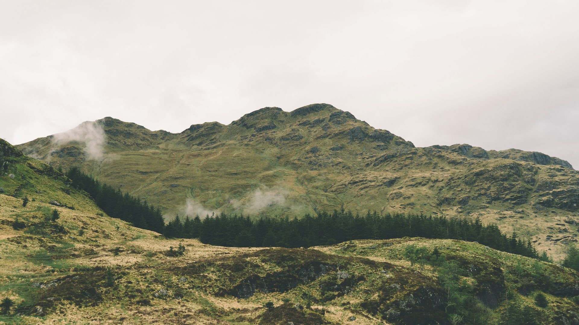 green mountain under cloudy sky