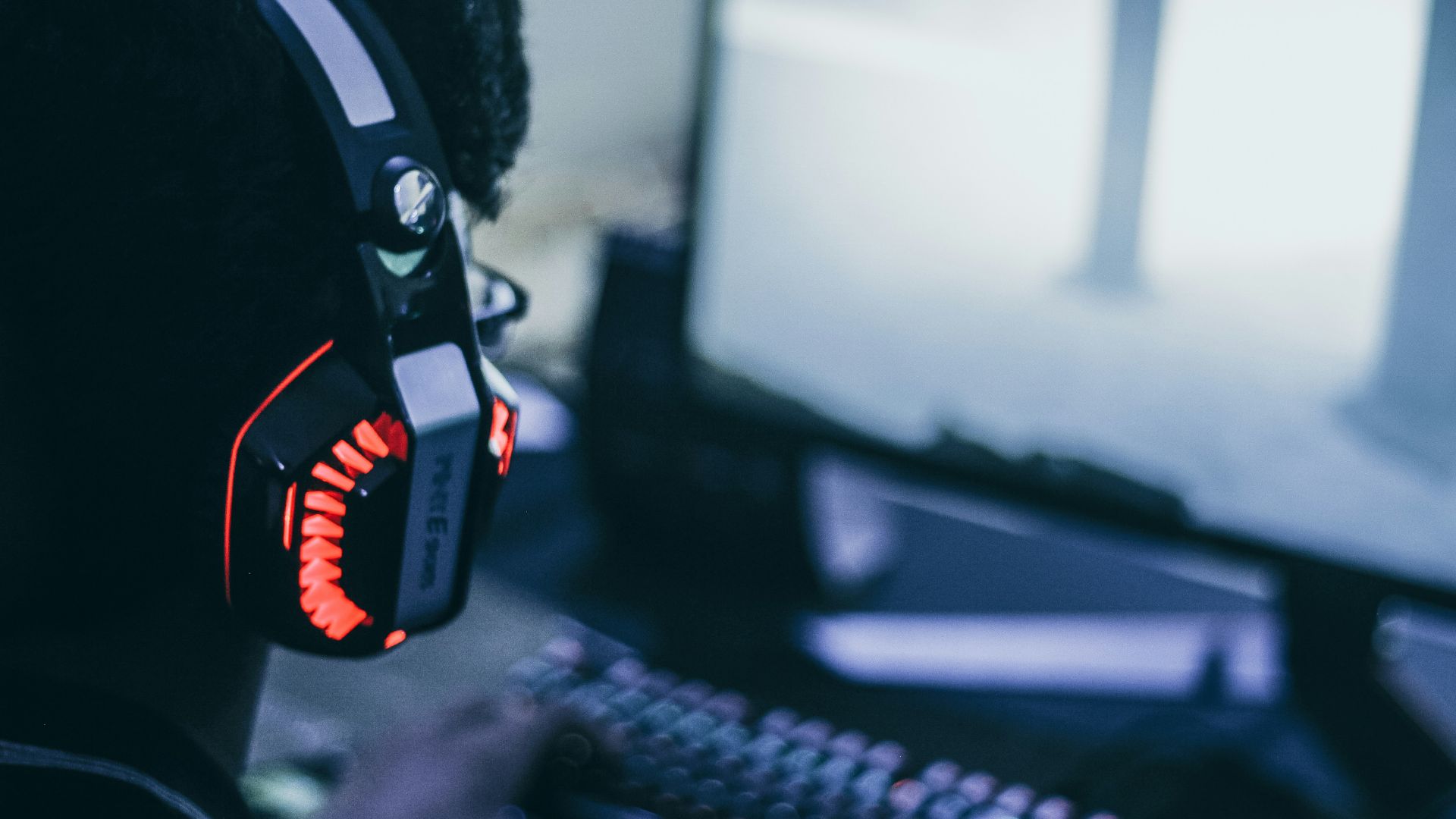 person wearing orange and black headphones