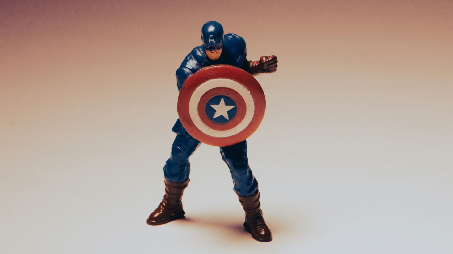 a toy of a captain america holding a shield