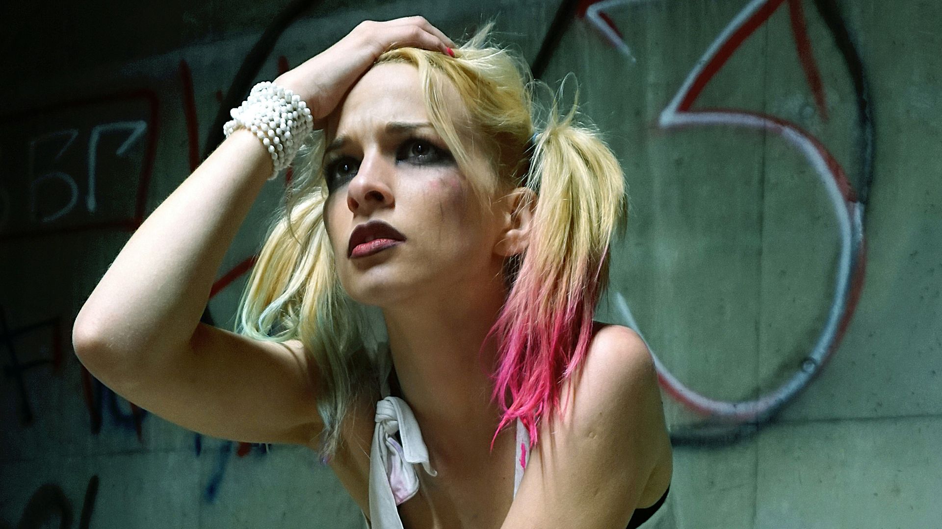 woman wearing fish net legging holding her head