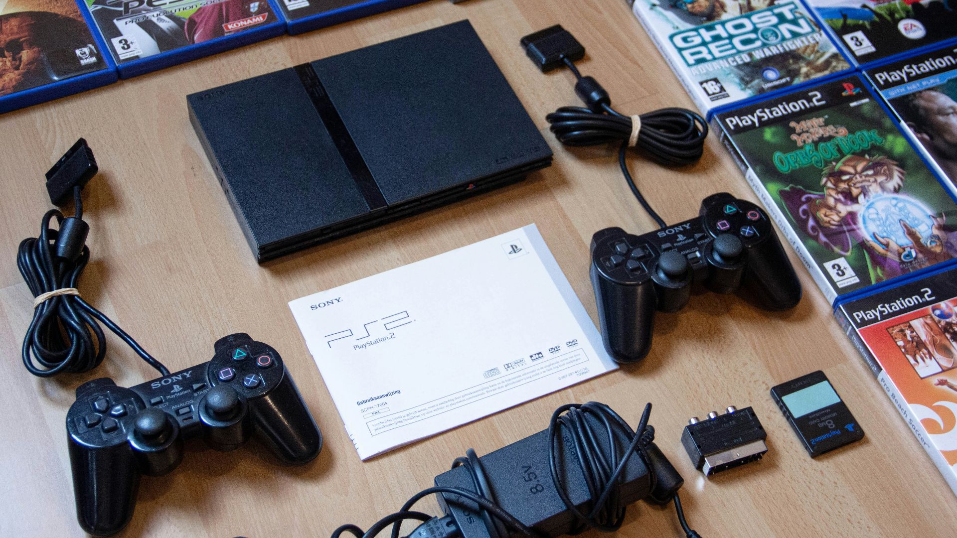 black sony ps 4 game controller on brown wooden table