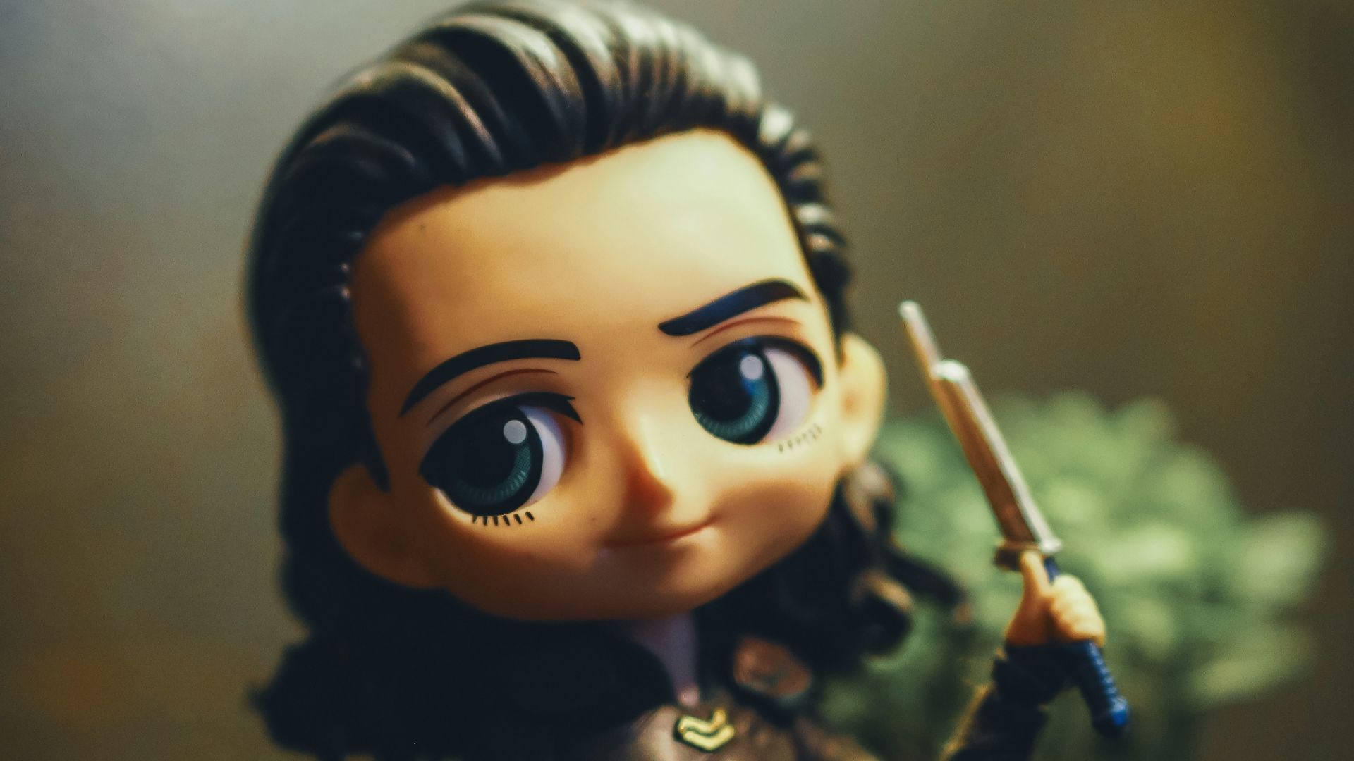 a close up of a figurine of a person holding a sword