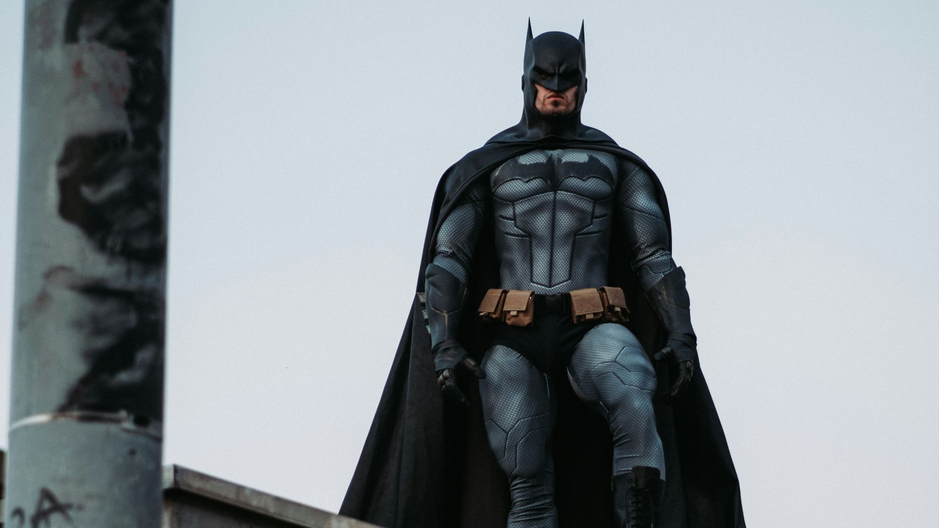 man in black jacket and pants standing on roof