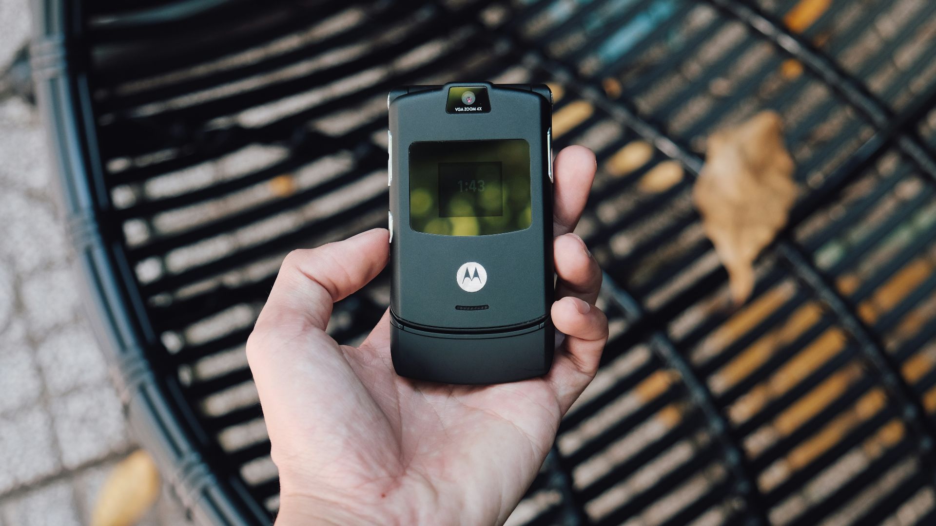 black samsung flip phone on persons hand