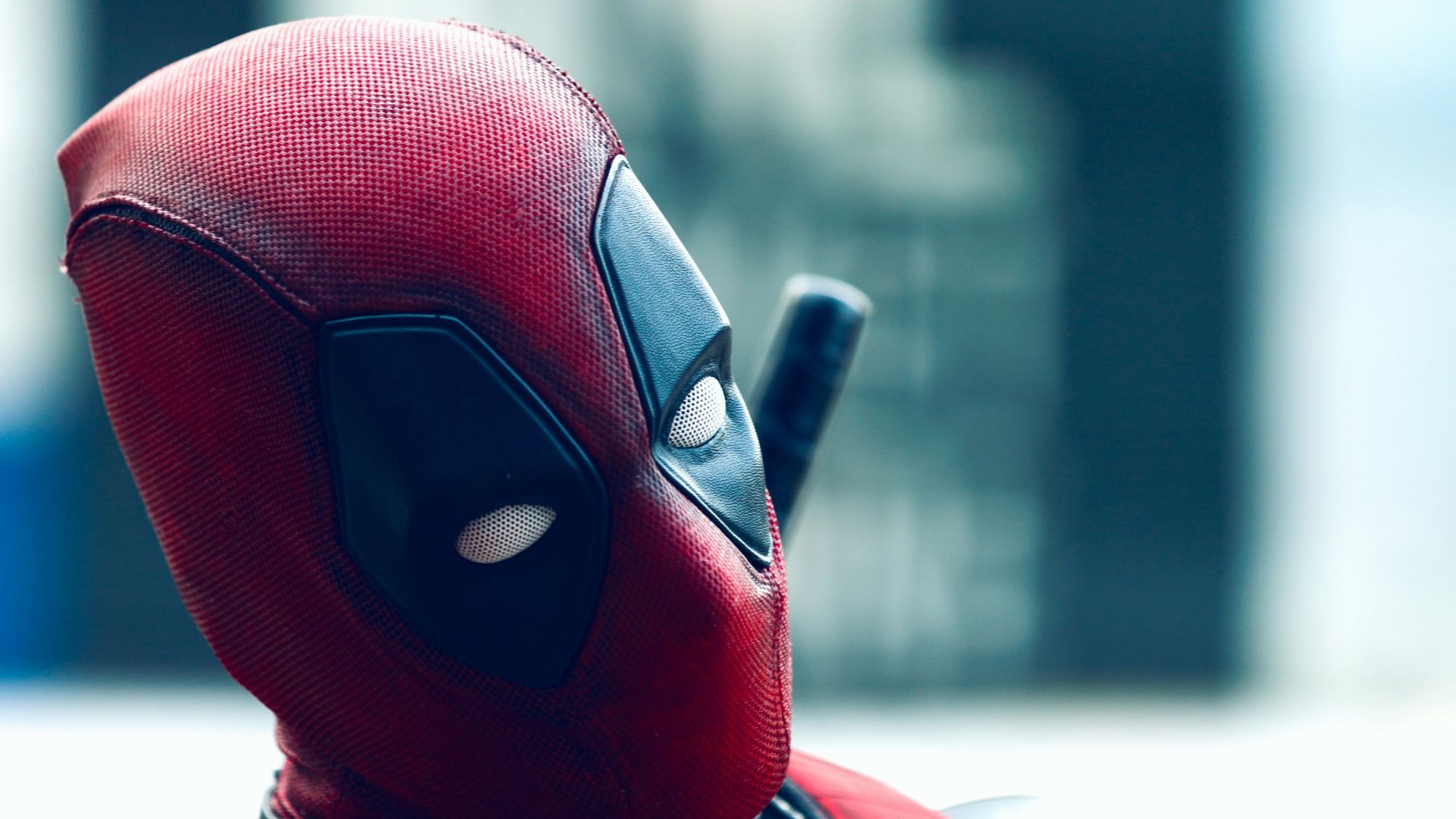 a man in a deadpool costume with a knife in his hand