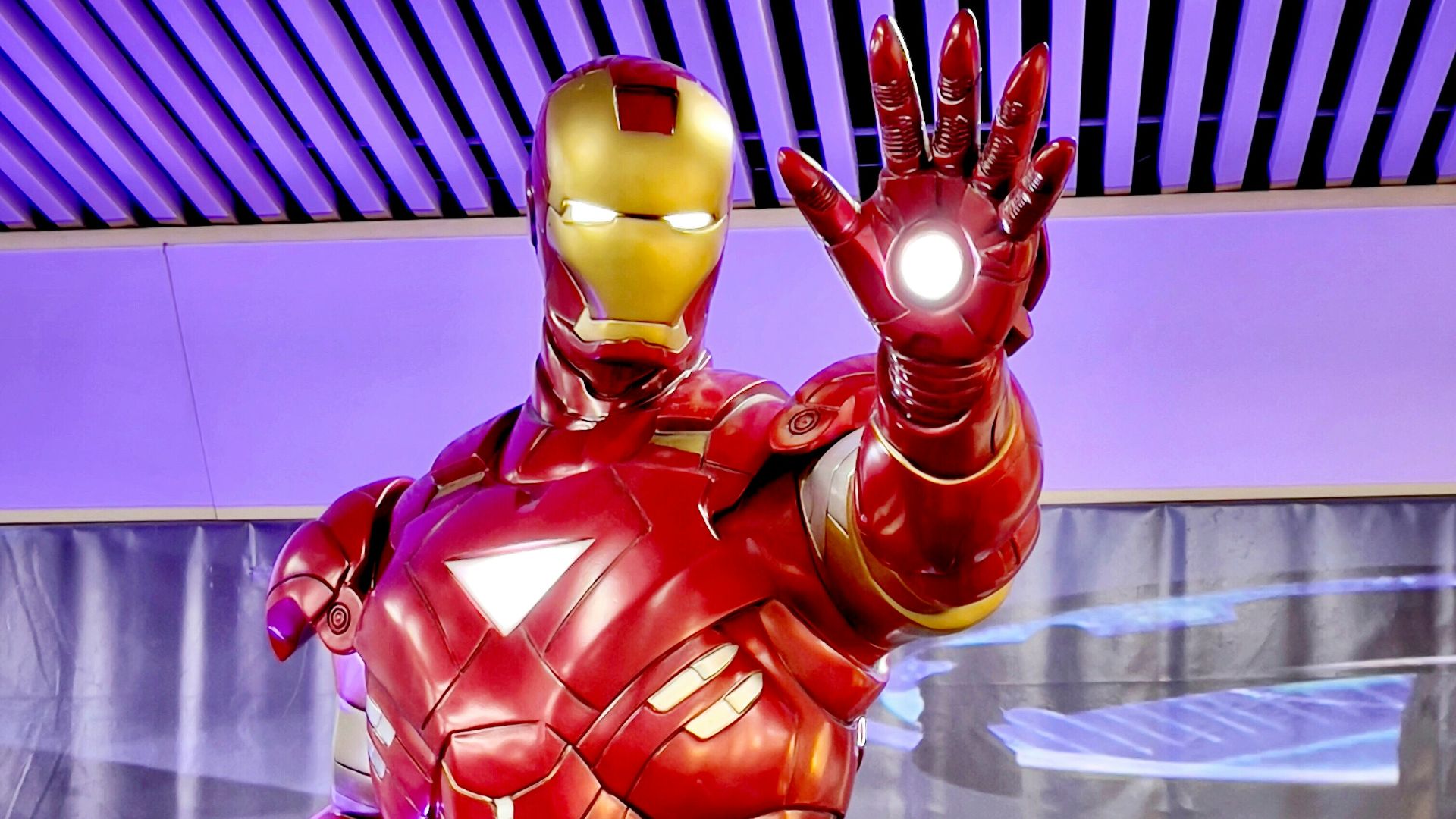 a statue of iron man is displayed in a museum