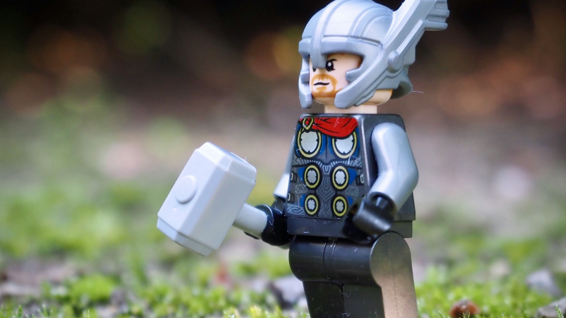 lego minifig on green grass during daytime