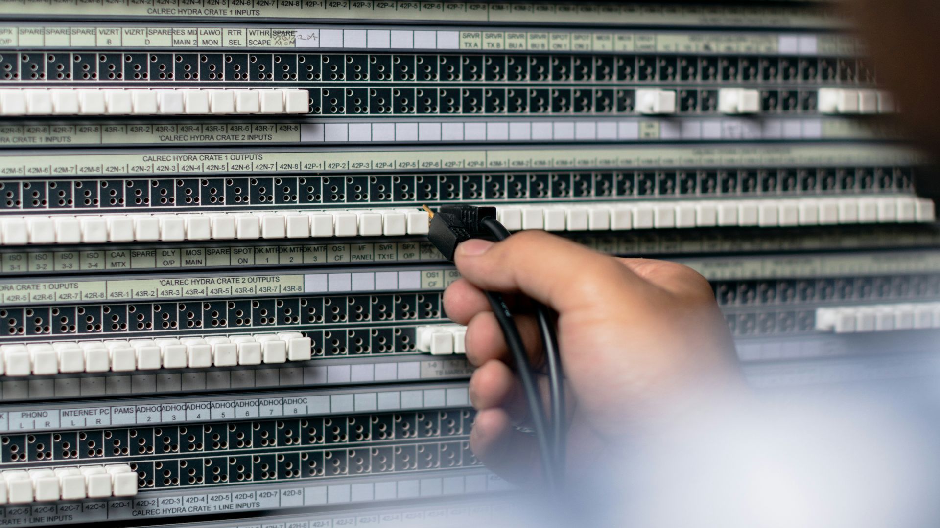 person holding gray and black audio mixer