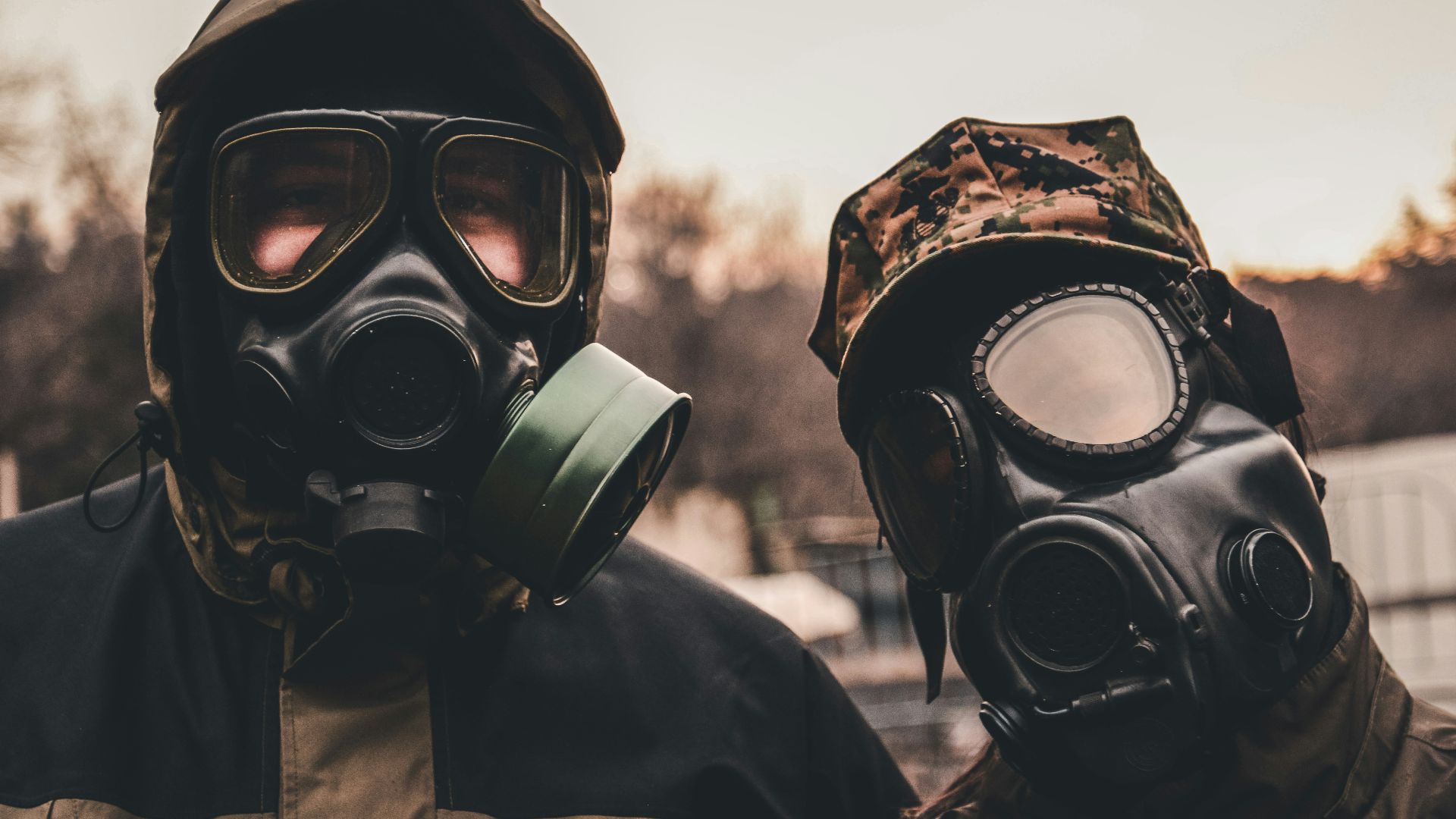 grayscale photo of person wearing gas mask