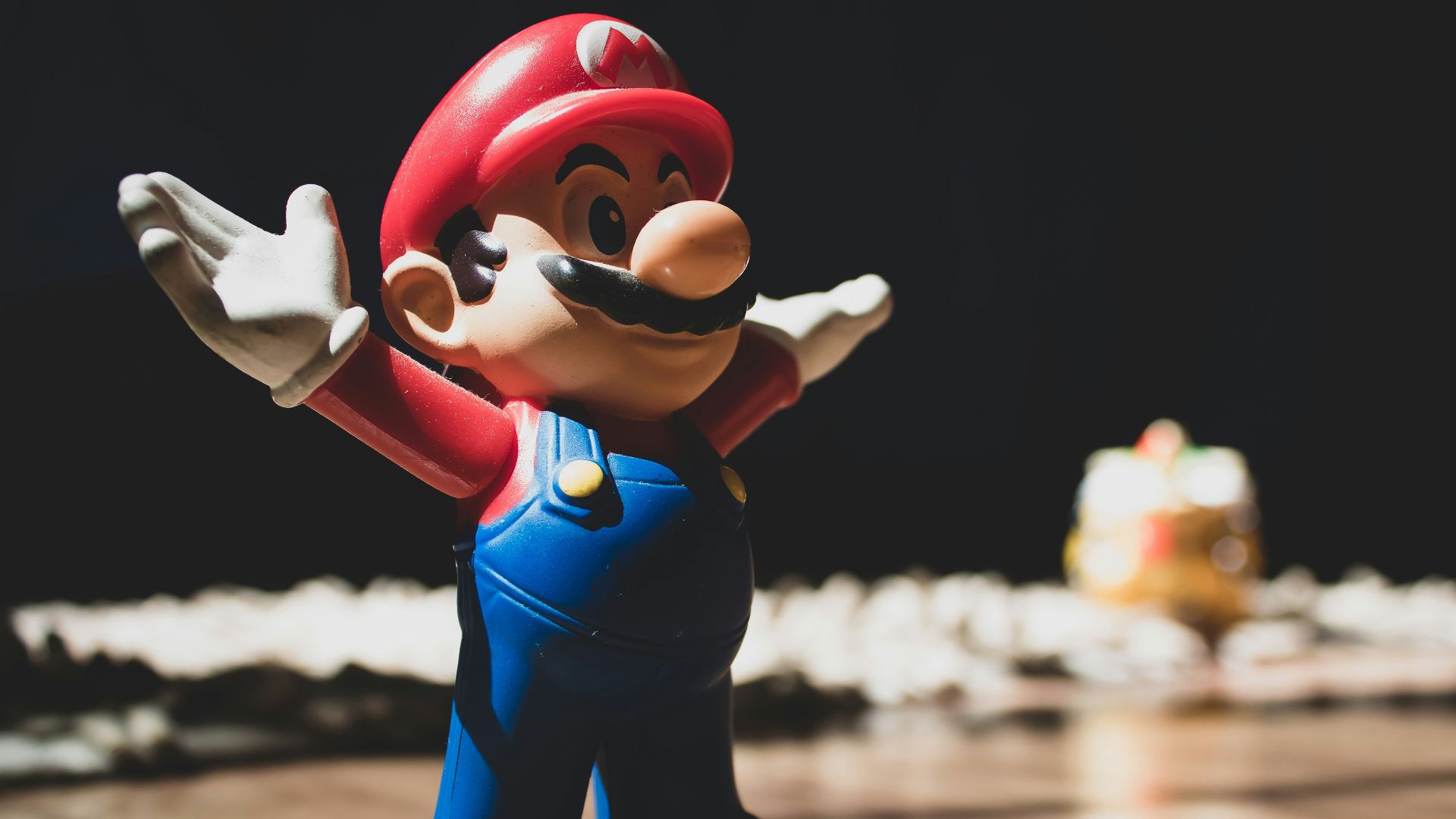 Super Mario figurine on brown surface