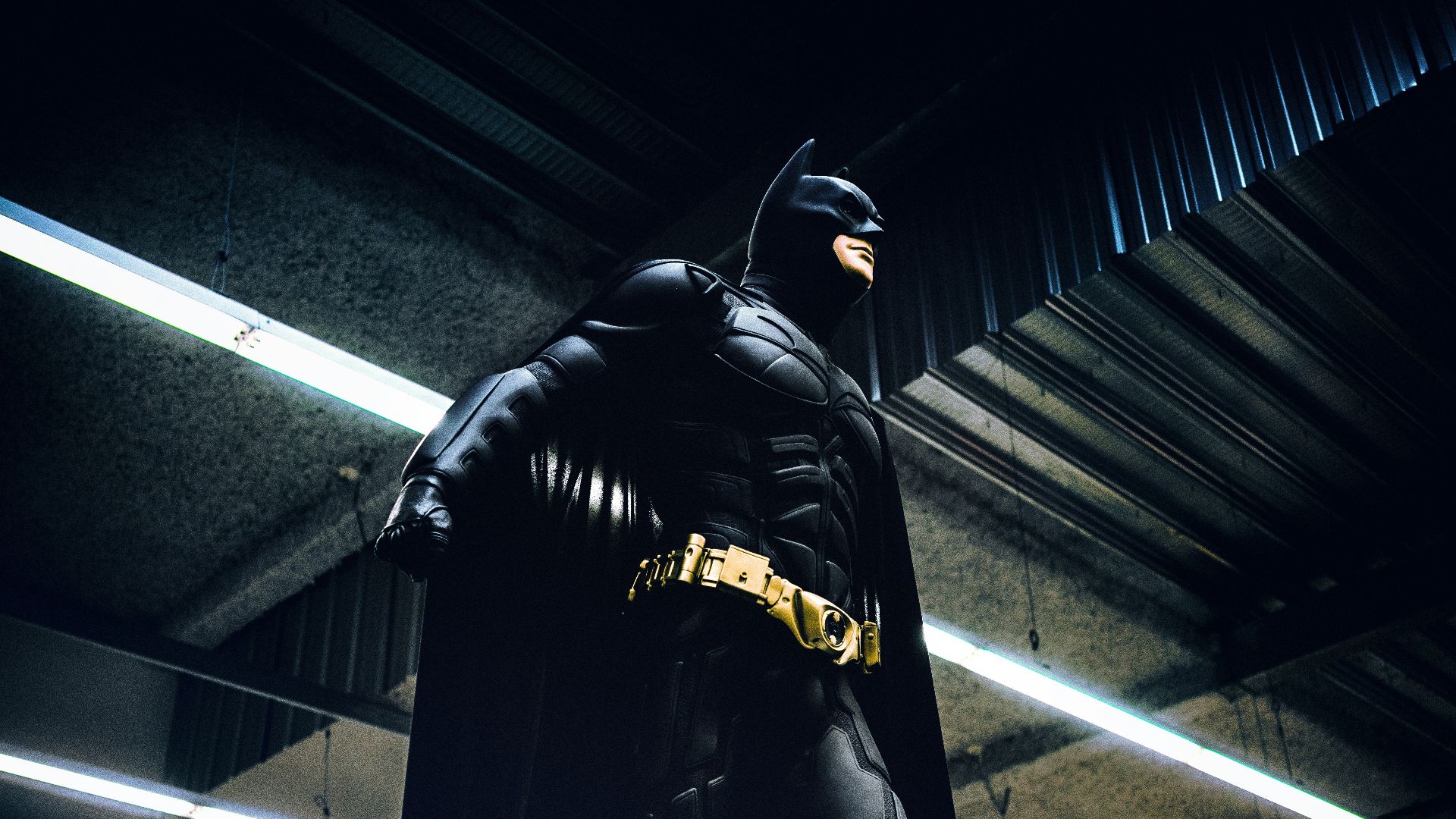 Batman standing under steel roof