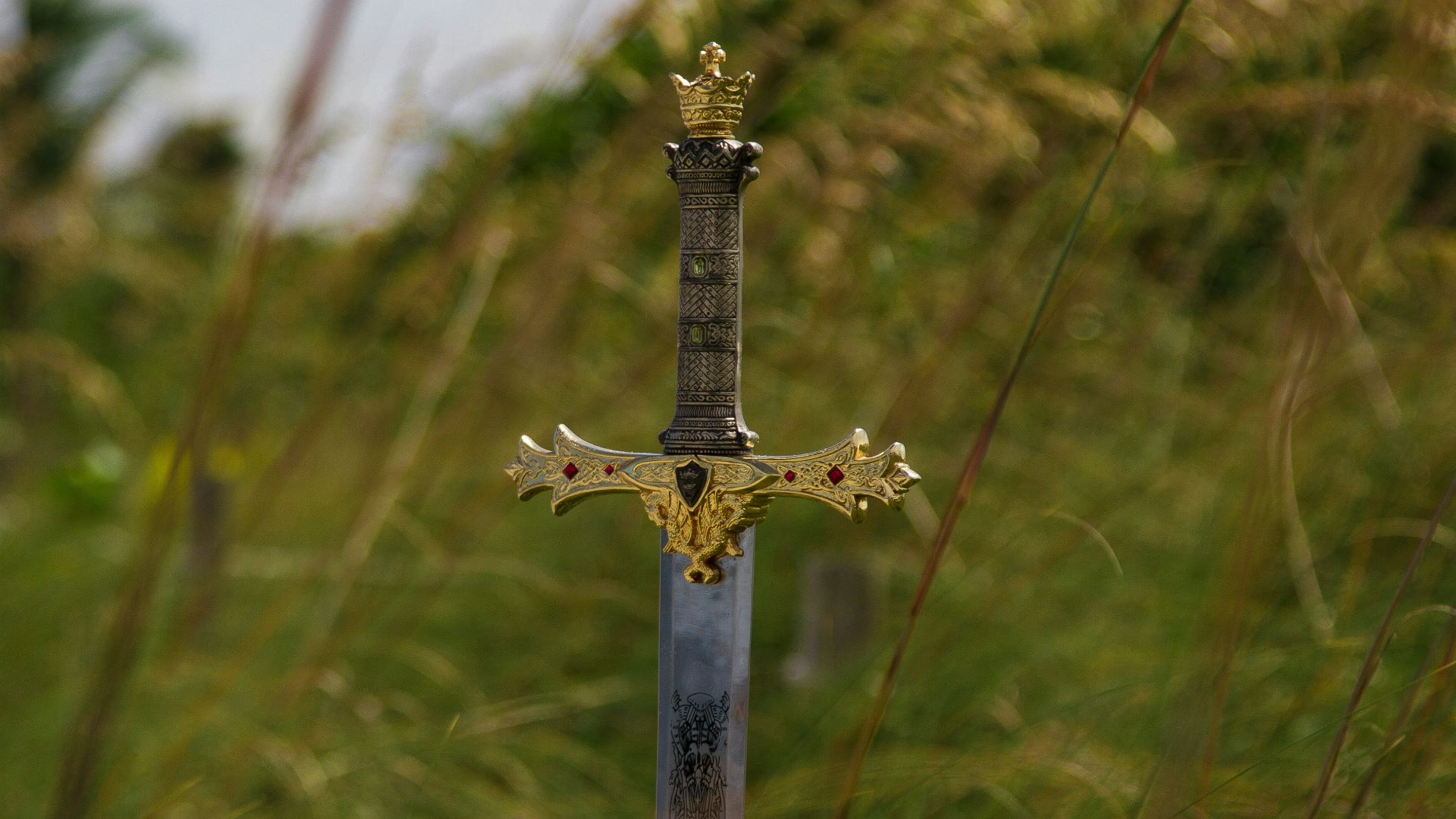 gray steel sword on ground during daytime