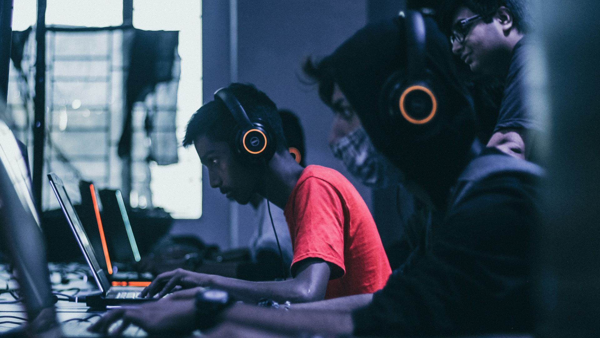 man playing on laptop