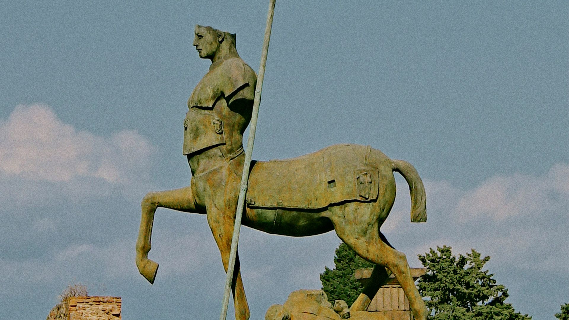 a statue of a man on a horse holding a flag