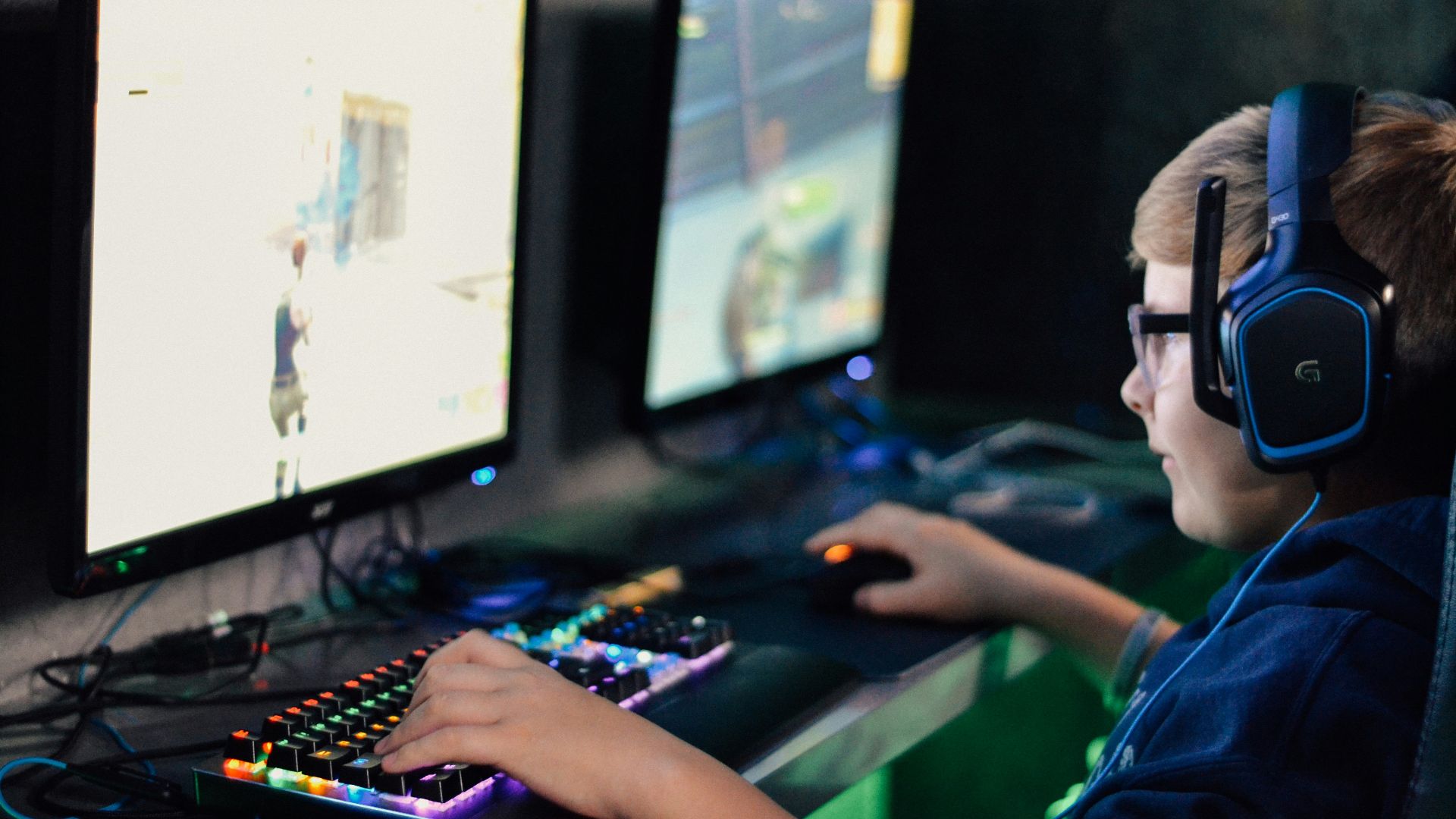 boy wearing headset playing computer game