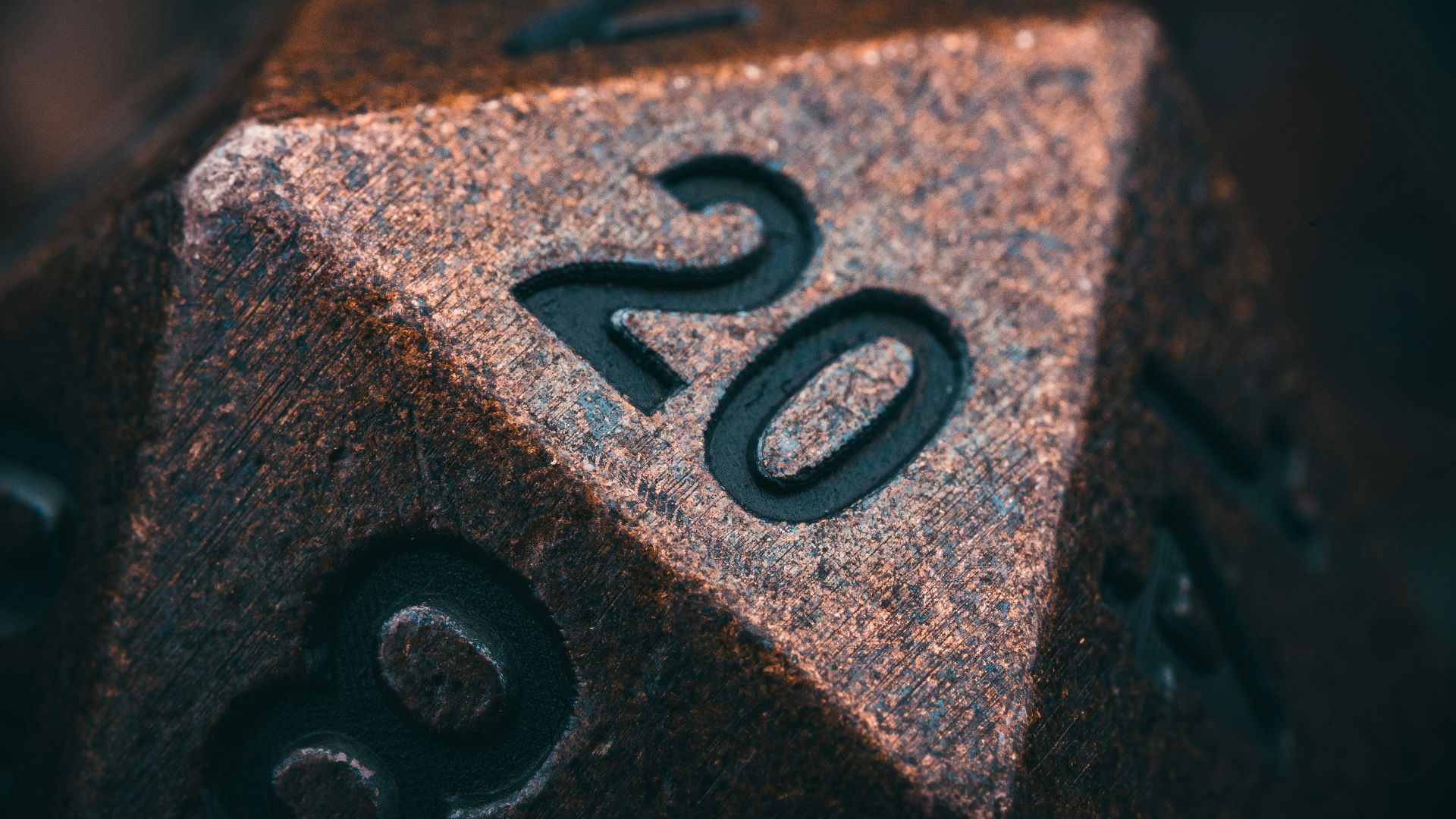 a metal dice with the number twenty on it