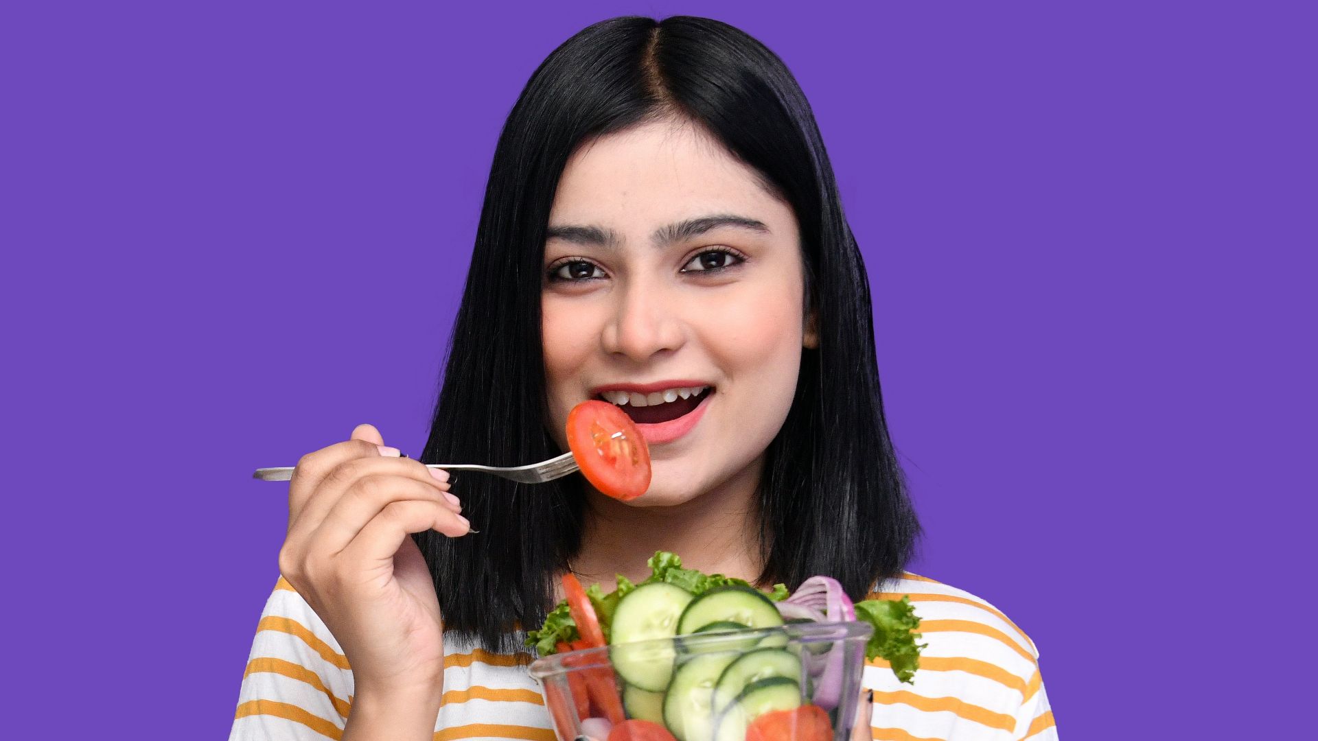 a woman holding a fruit