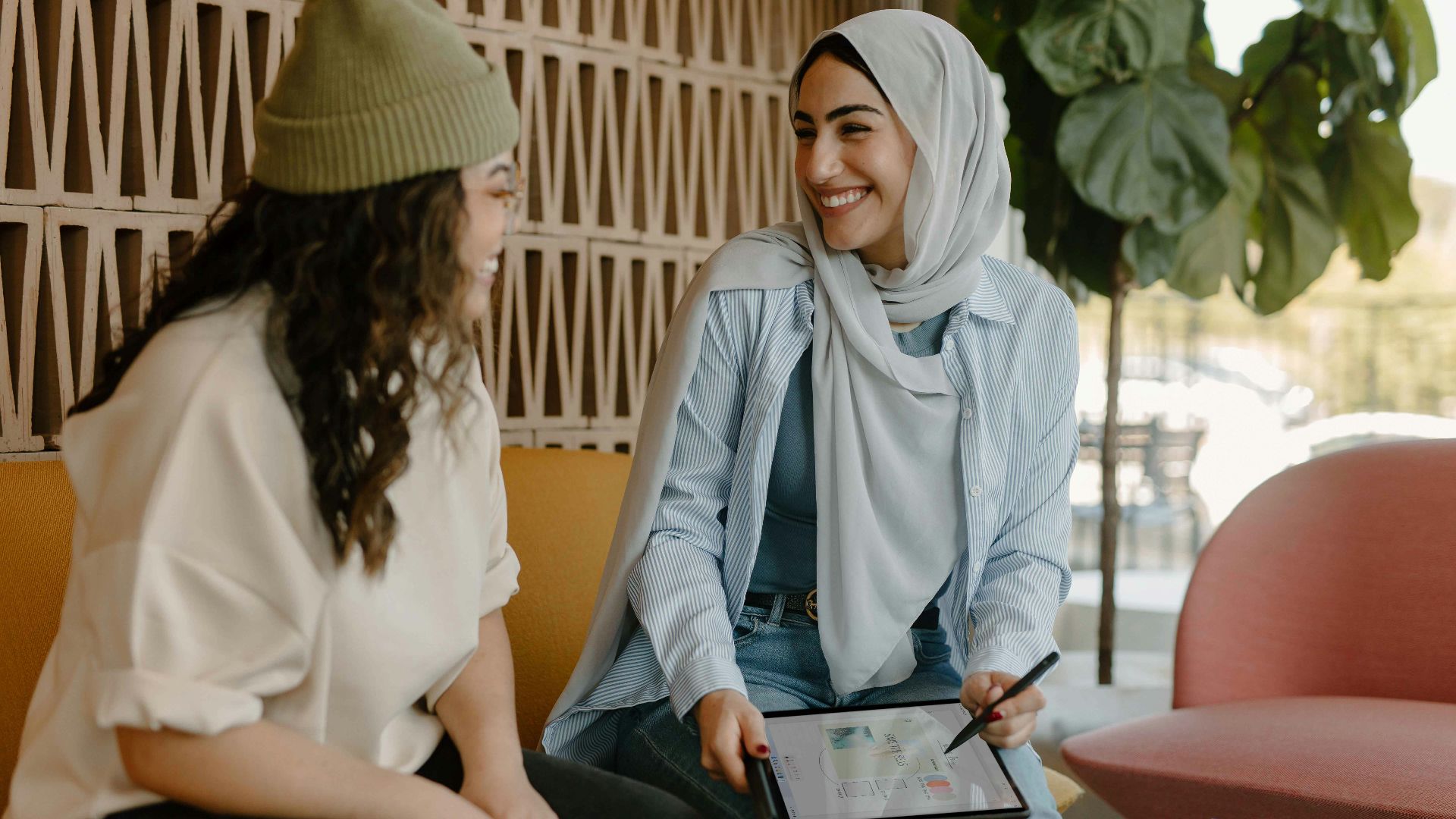 a couple of women sitting on a couch