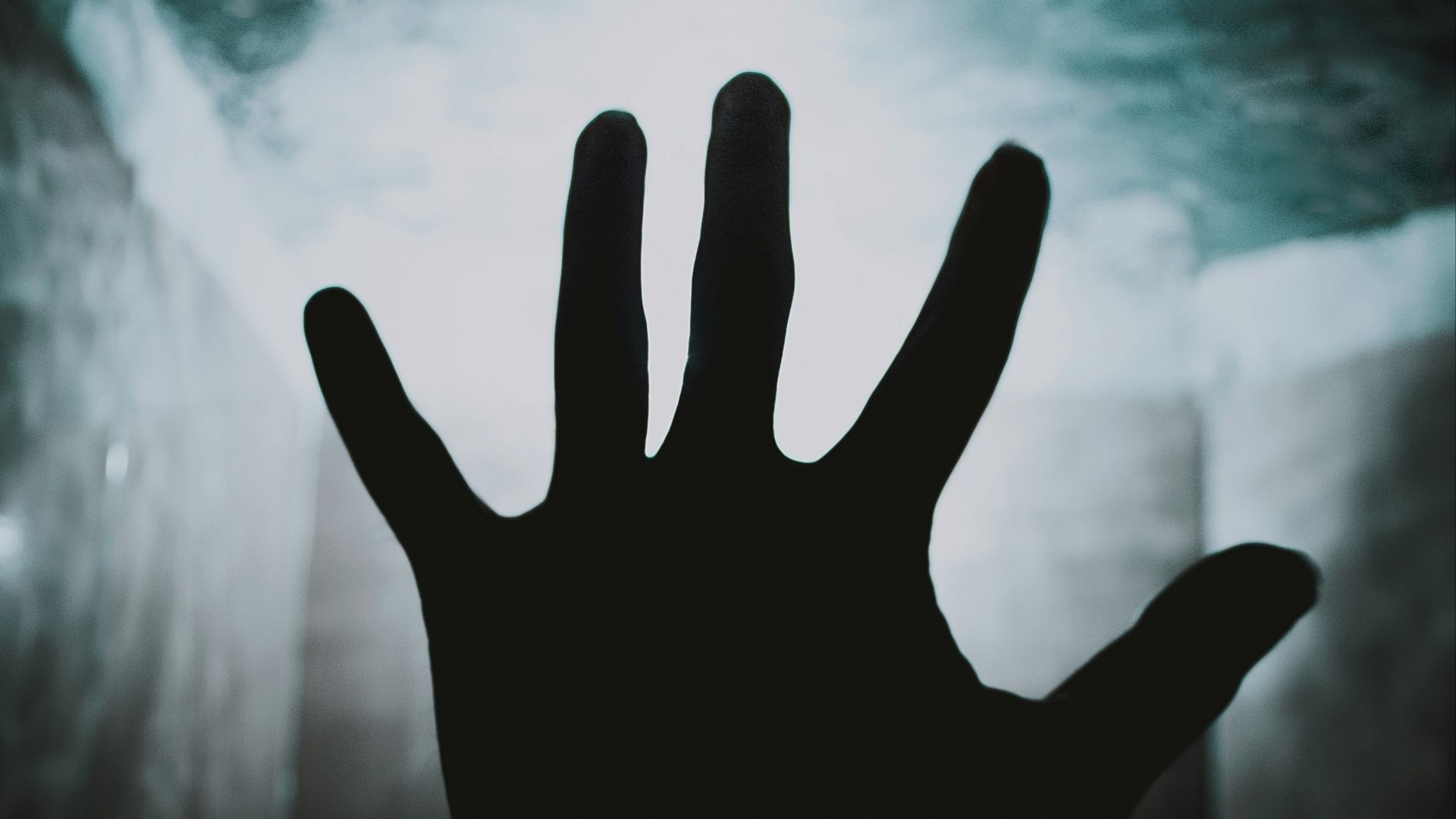 a person's hand reaching up into the air