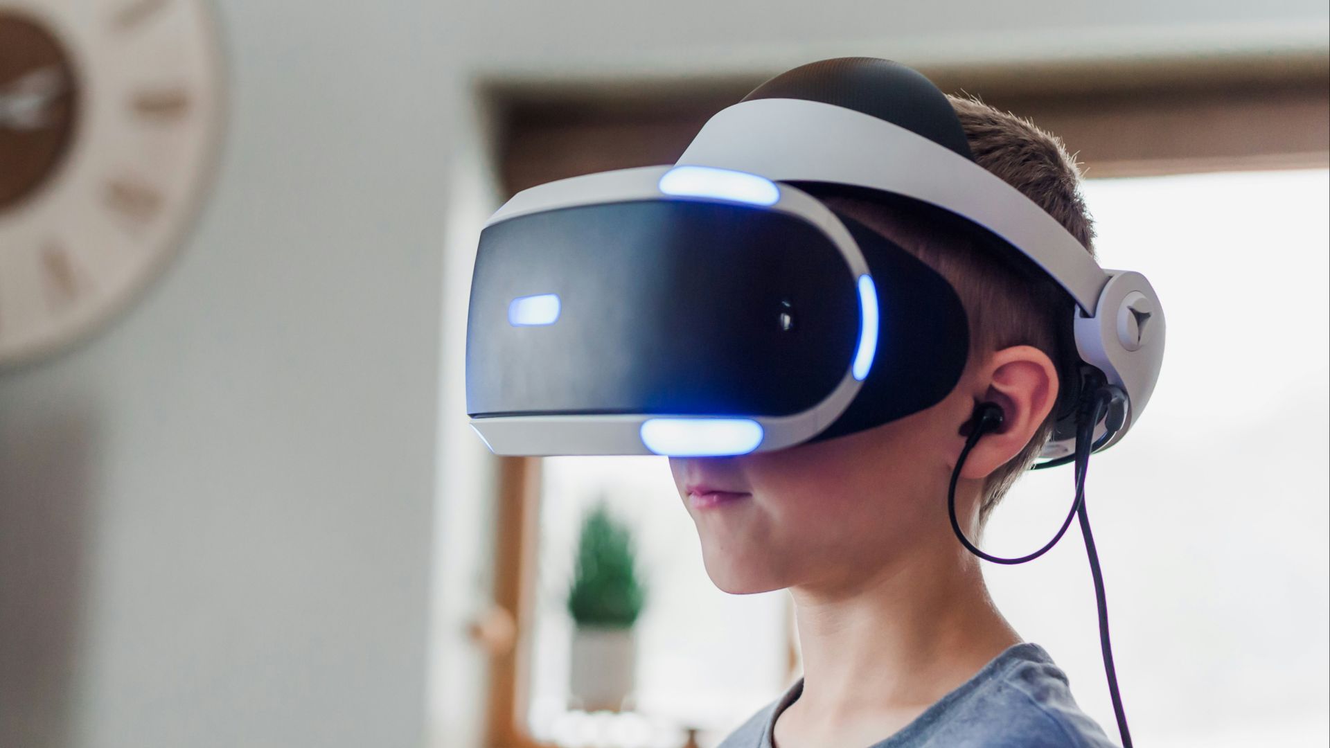 boy wearing black and white VR headset