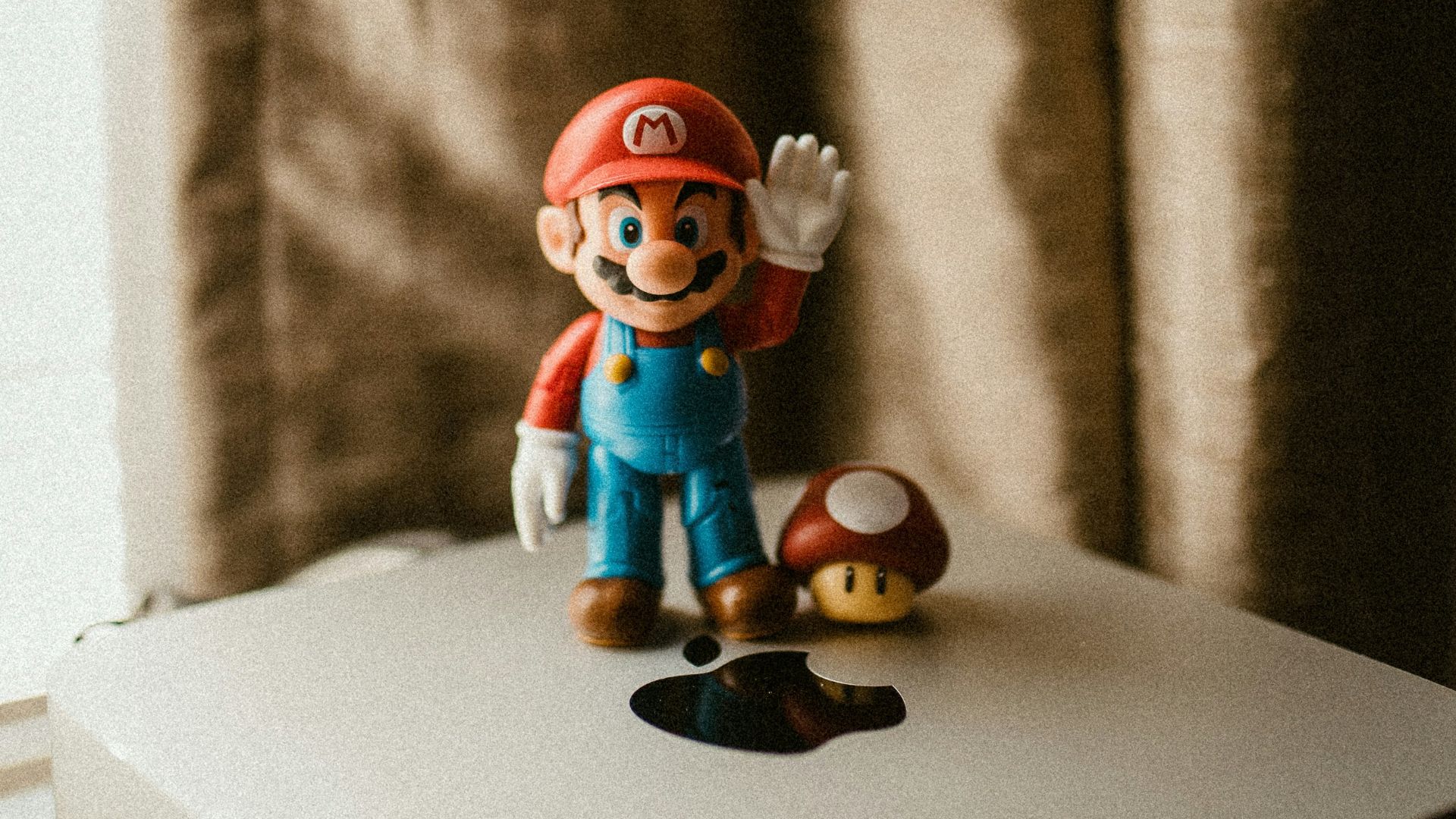 a nintendo figurine sitting on top of a white box