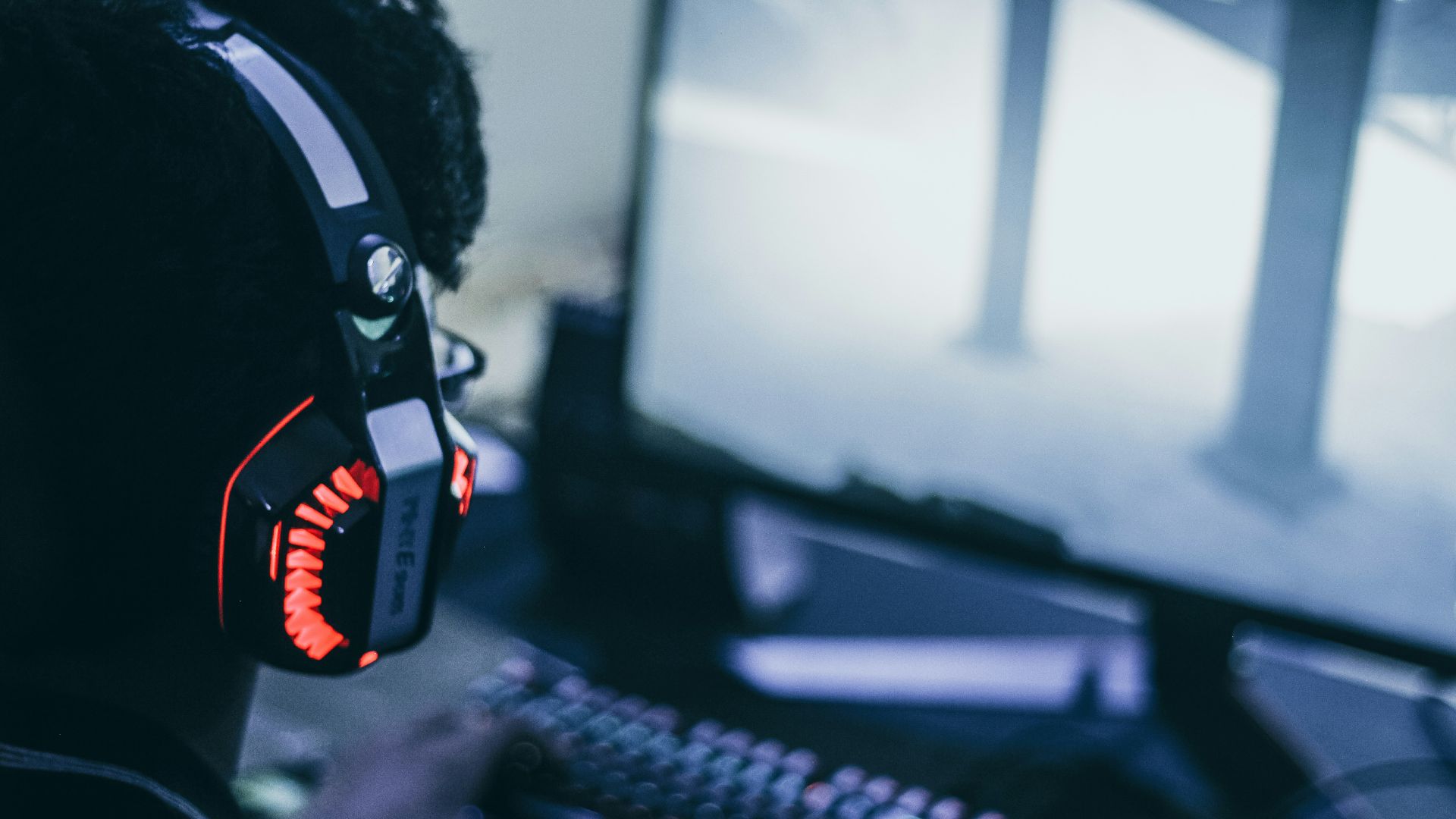 person wearing orange and black headphones