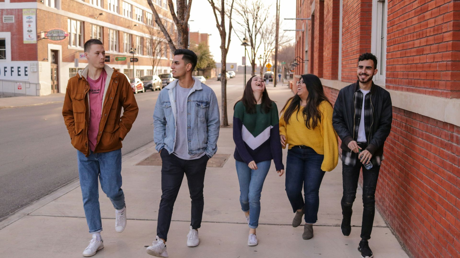three men and laughing two women walking side by side