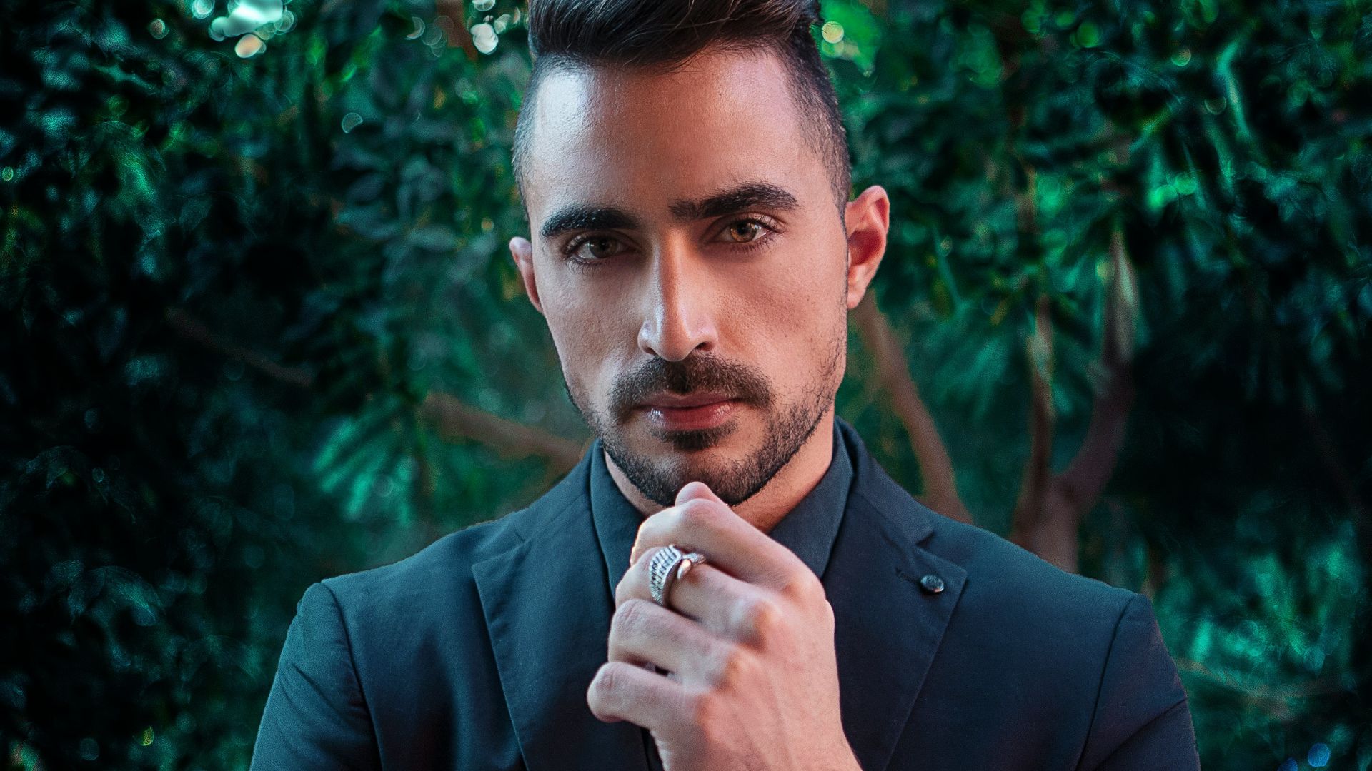 man in black suit jacket wearing silver ring