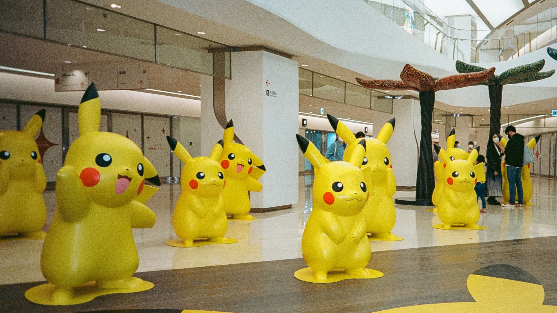 a group of pikachu statues in a building