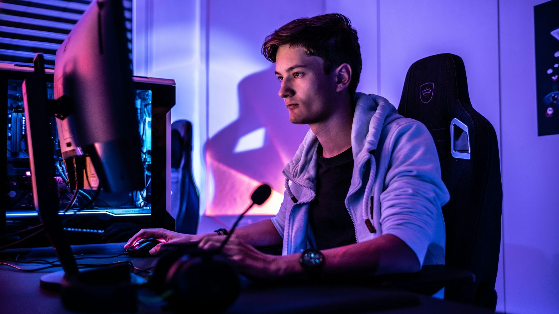 a man sitting in front of a computer monitor