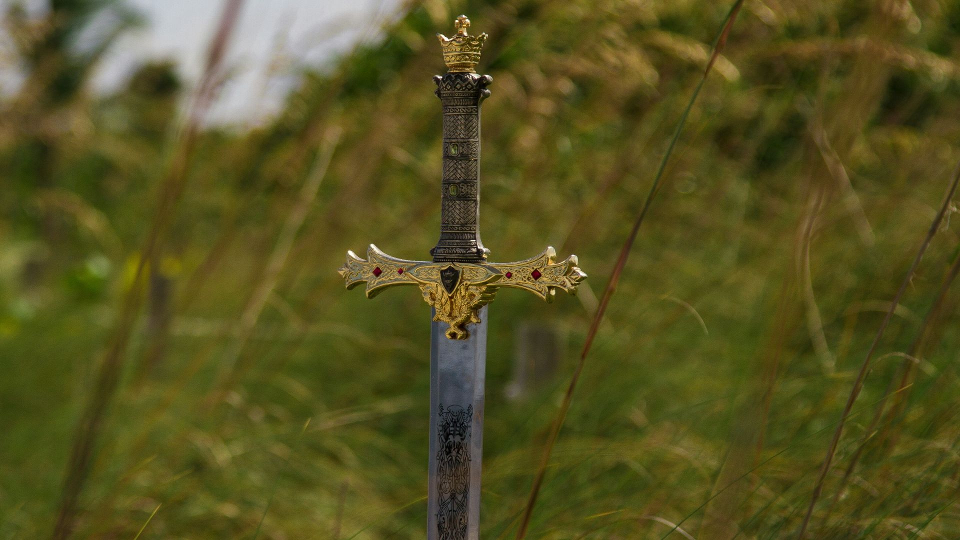 gray steel sword on ground during daytime