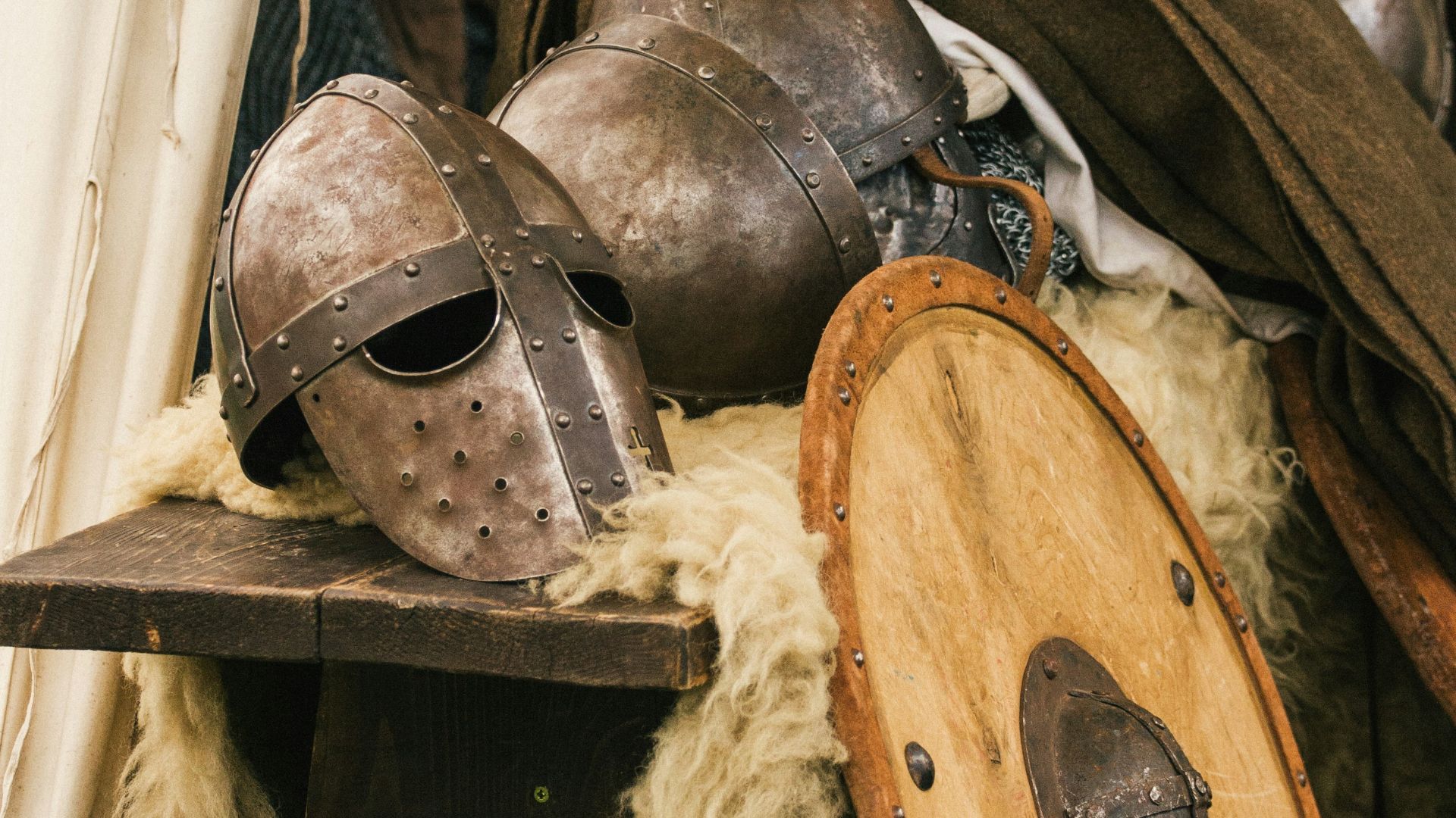 brown wooden round table with brown leather boots