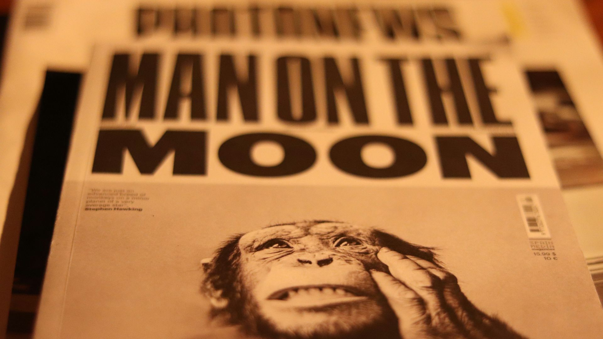 a close up of a newspaper with a monkey on it