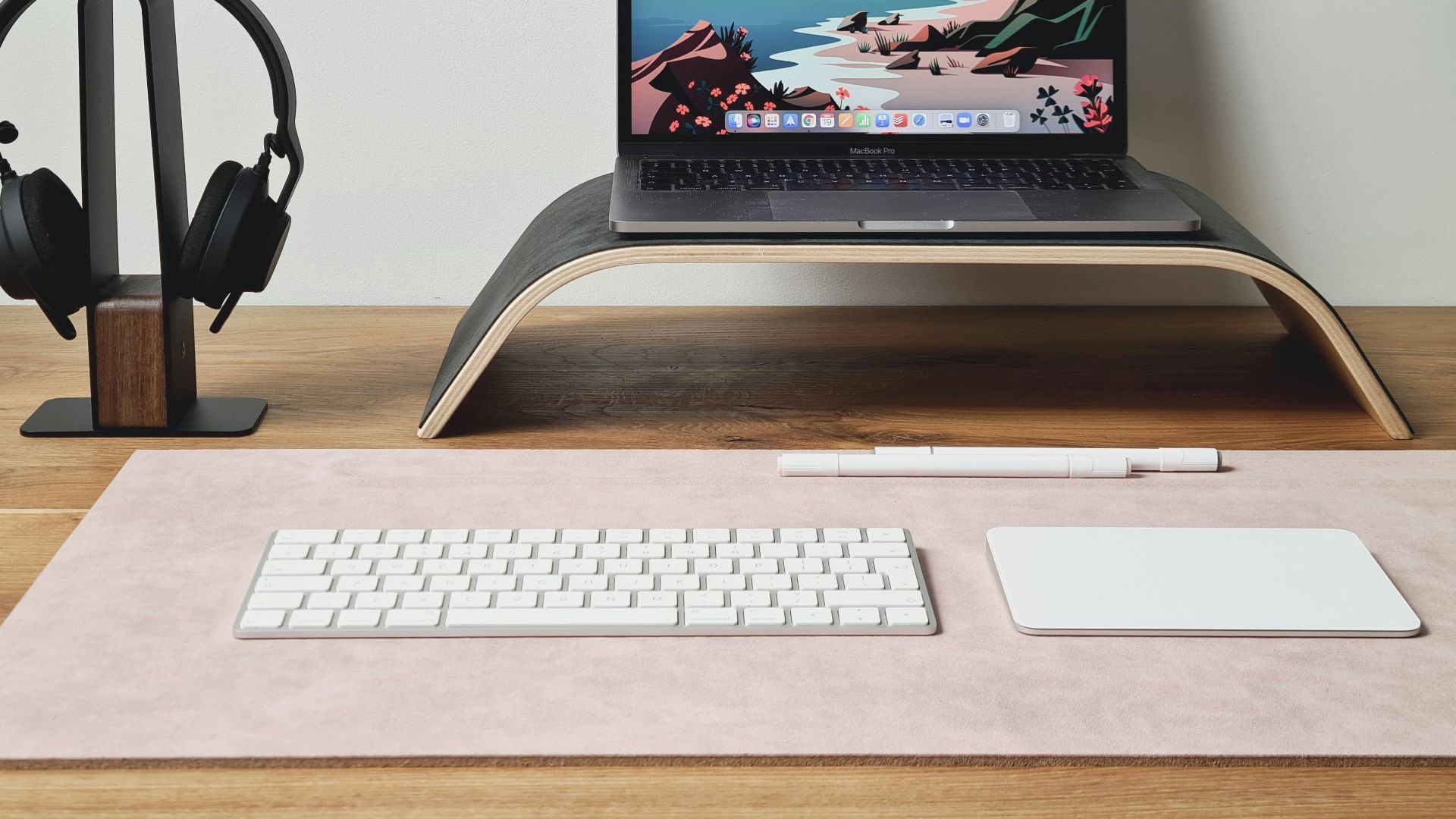 a laptop computer sitting on top of a wooden desk