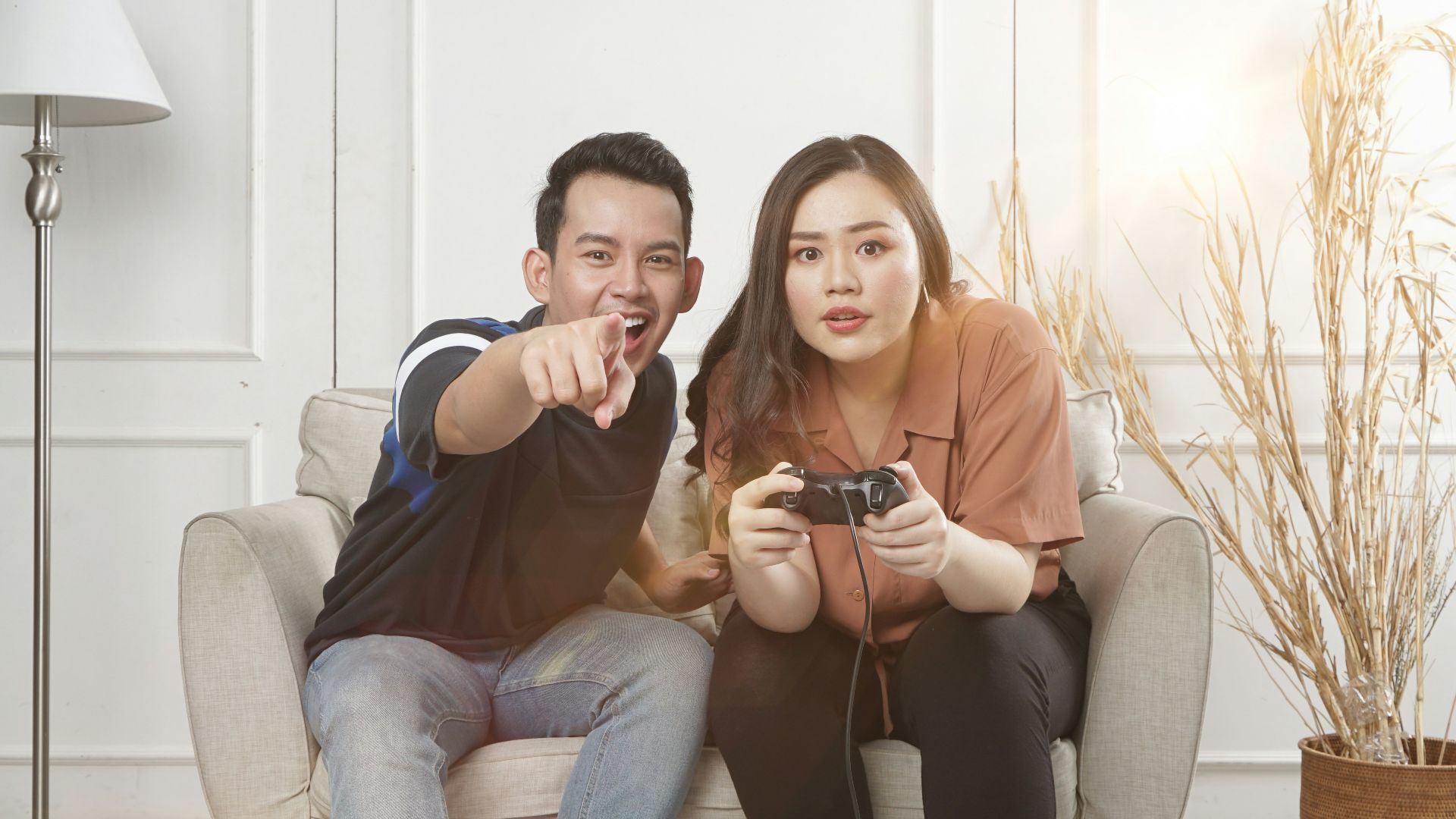 man and woman siting on sofa chair