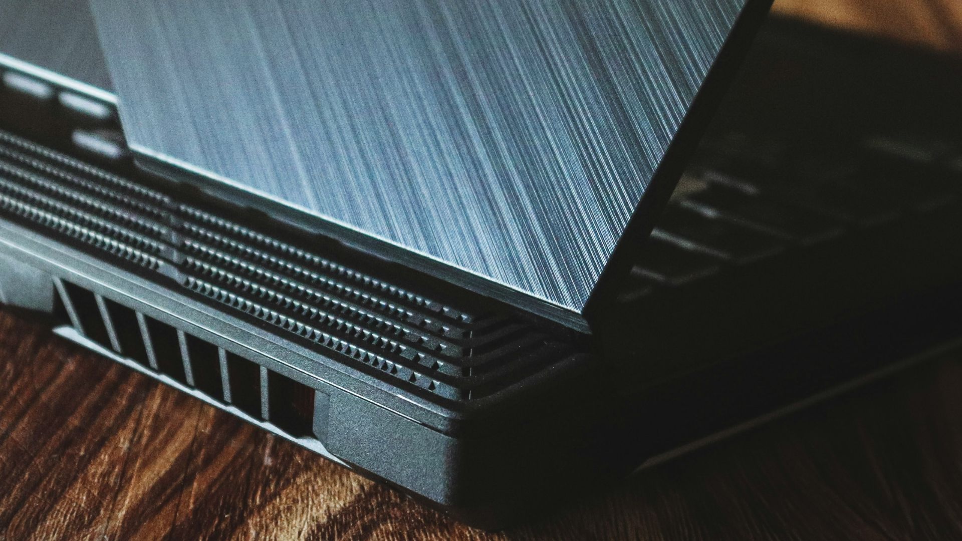 a laptop computer sitting on top of a wooden table