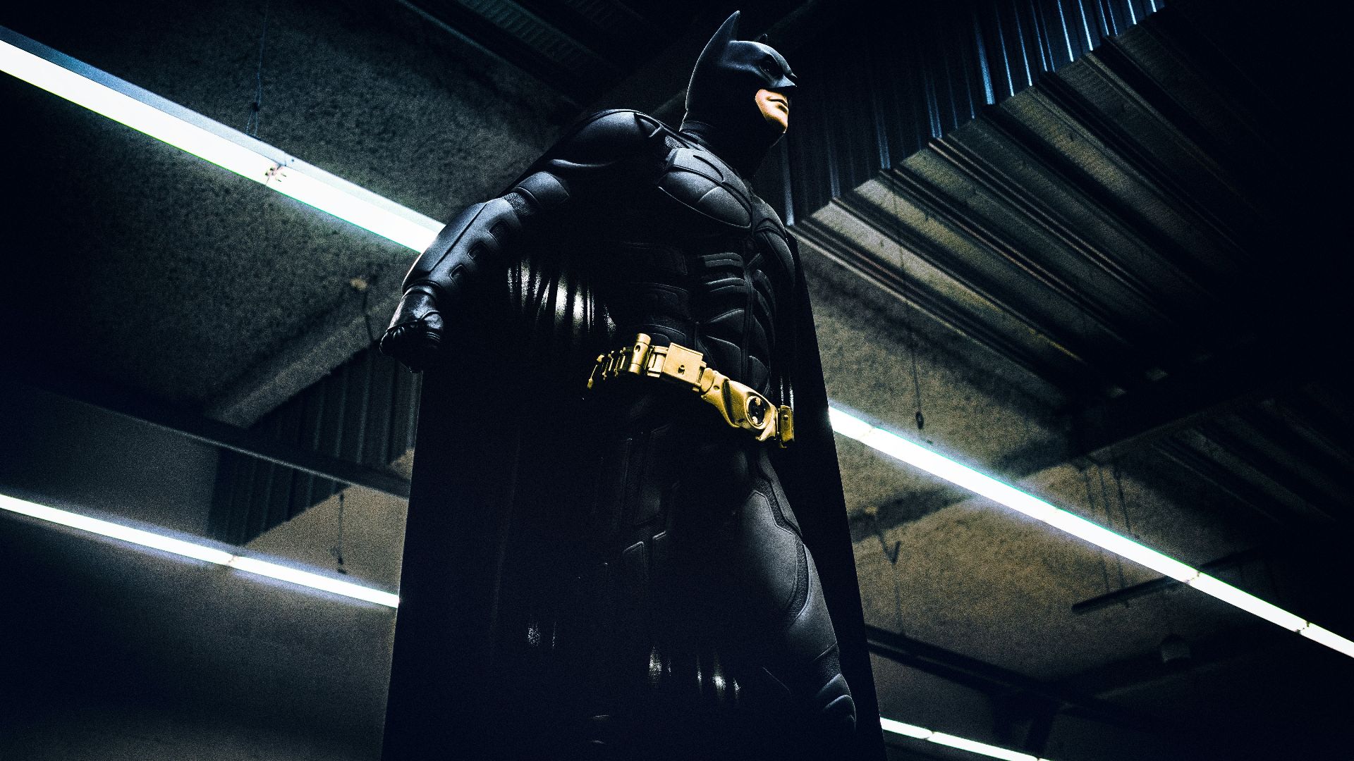 Batman standing under steel roof