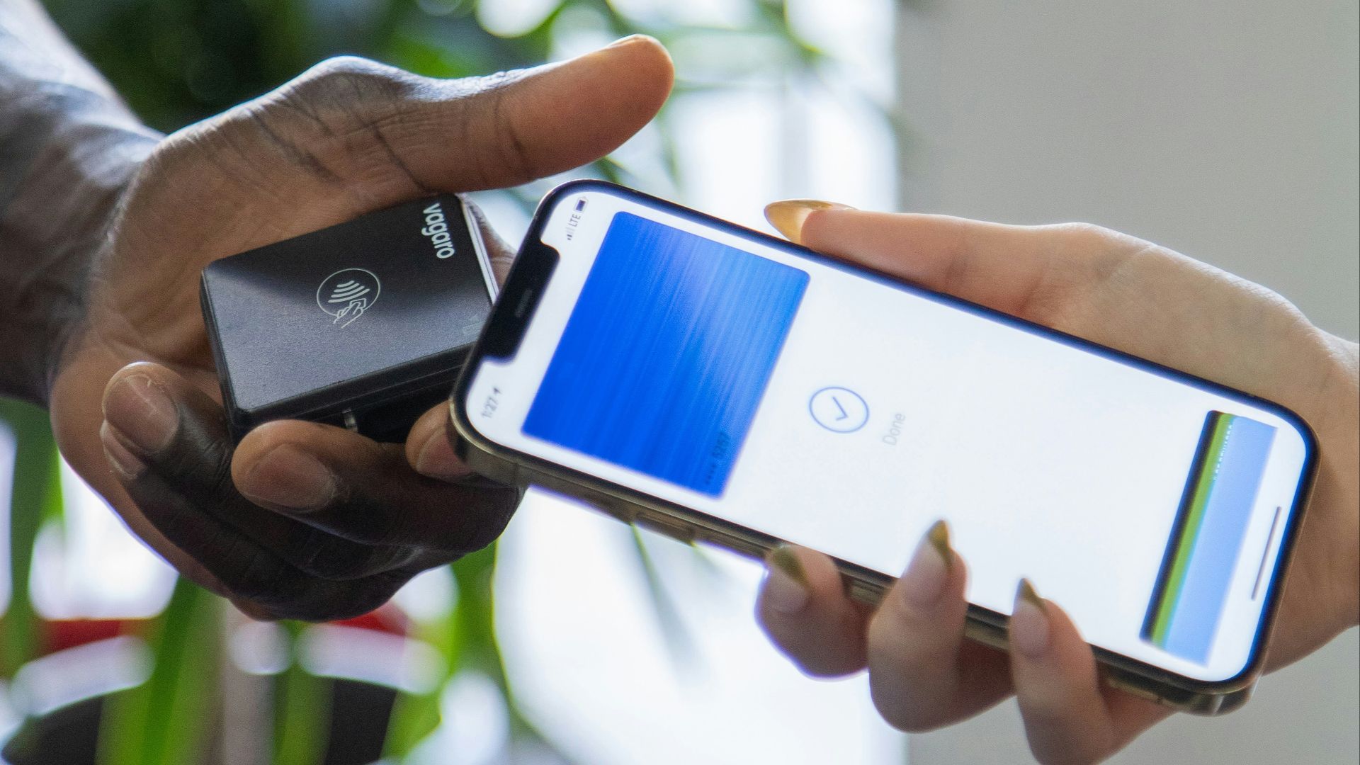 a person holding a cell phone in their hand