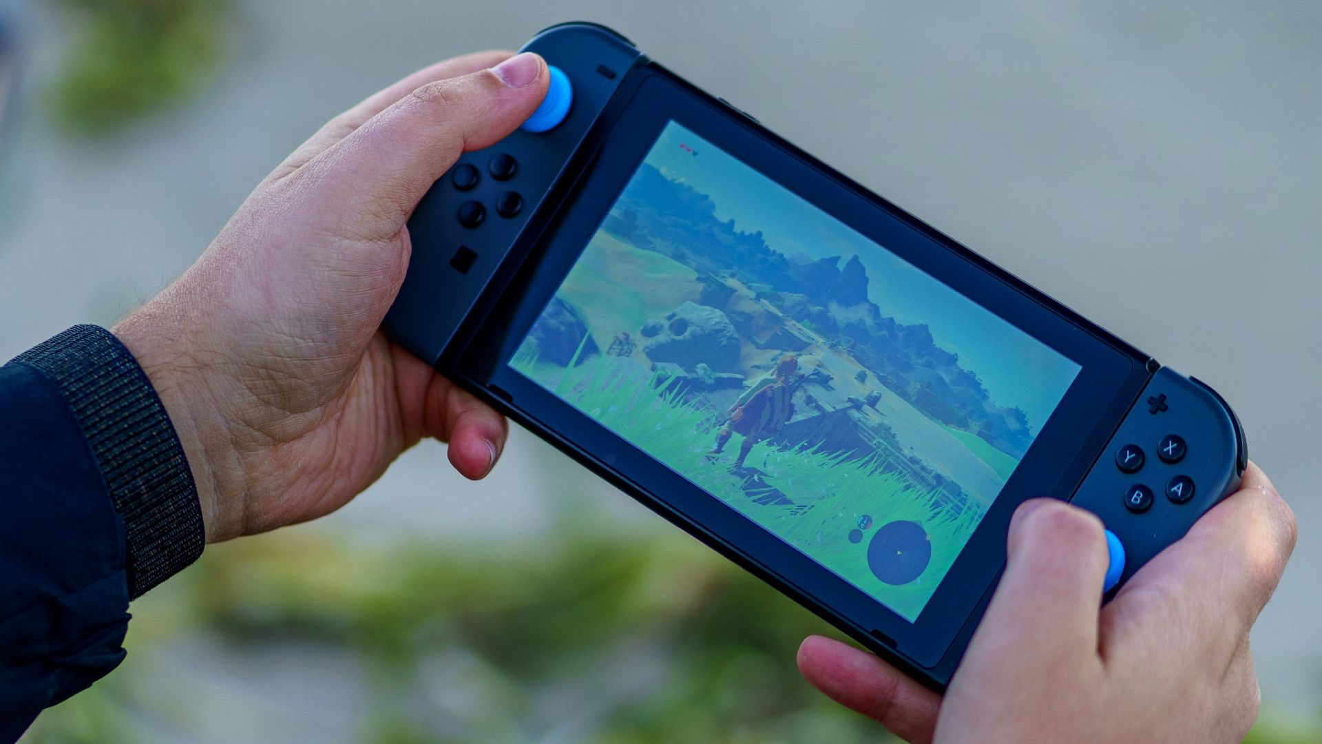 a person is playing a video game on a cell phone