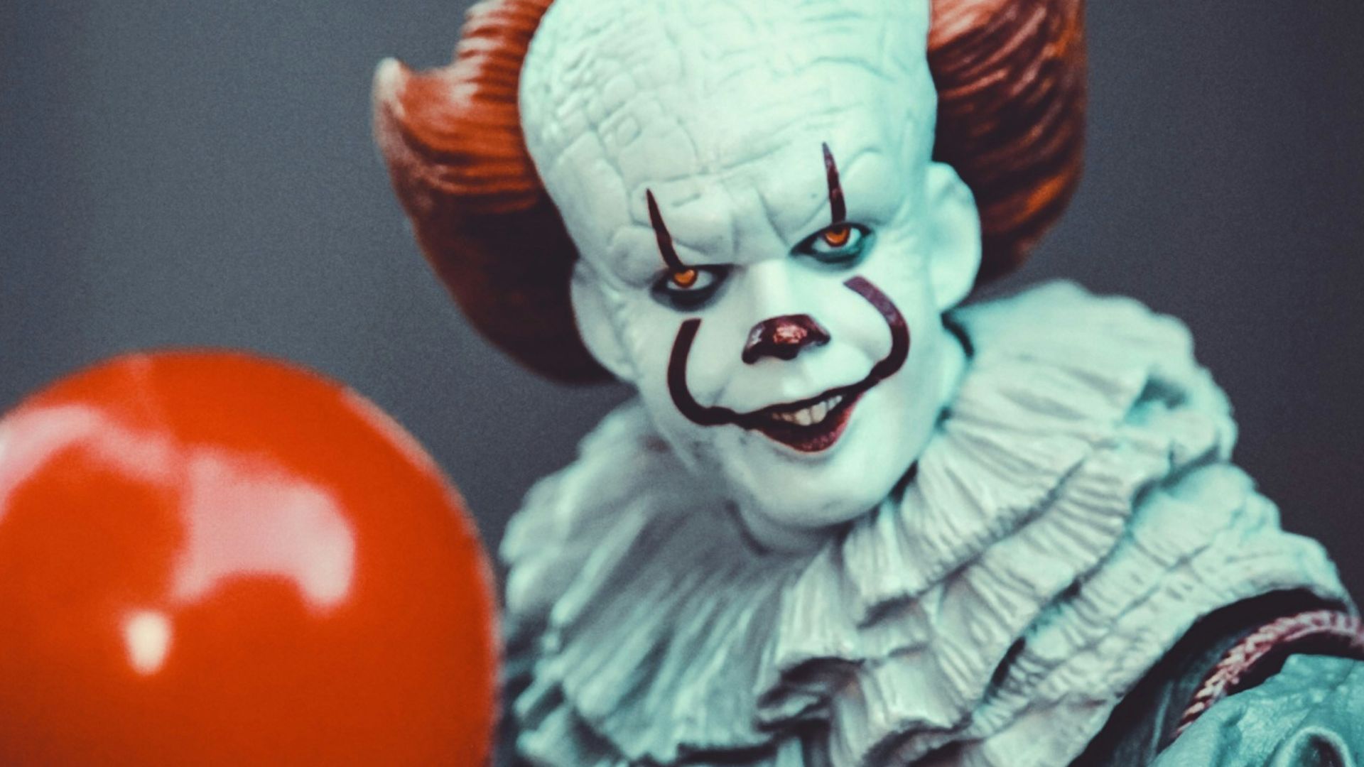 red ball on brown wooden surface