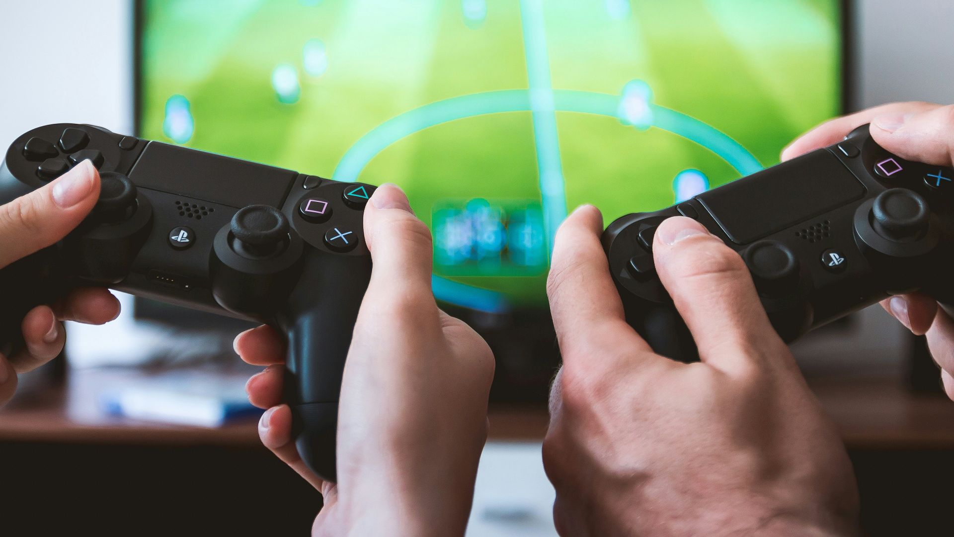 two people playing Sony PS4 game console