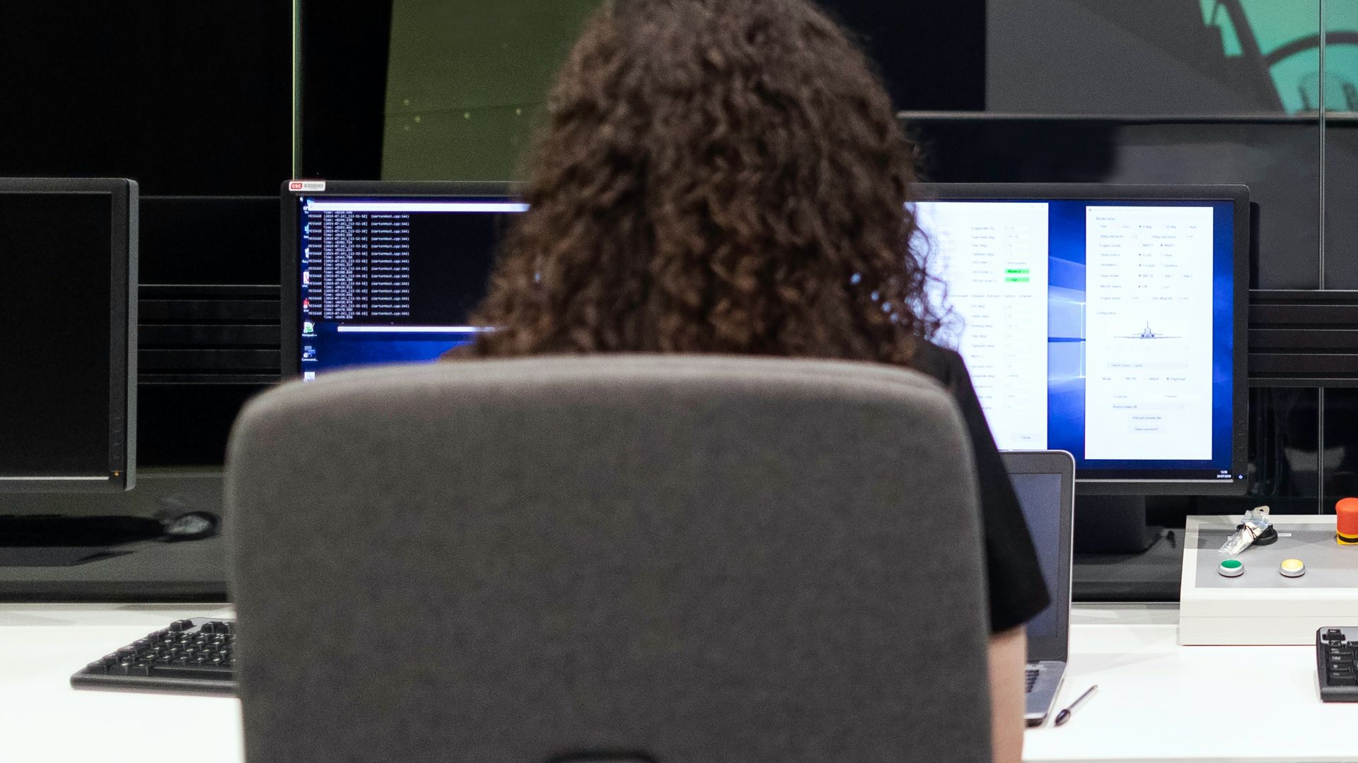 woman sitting on black office rolling chair in front of computer monitor