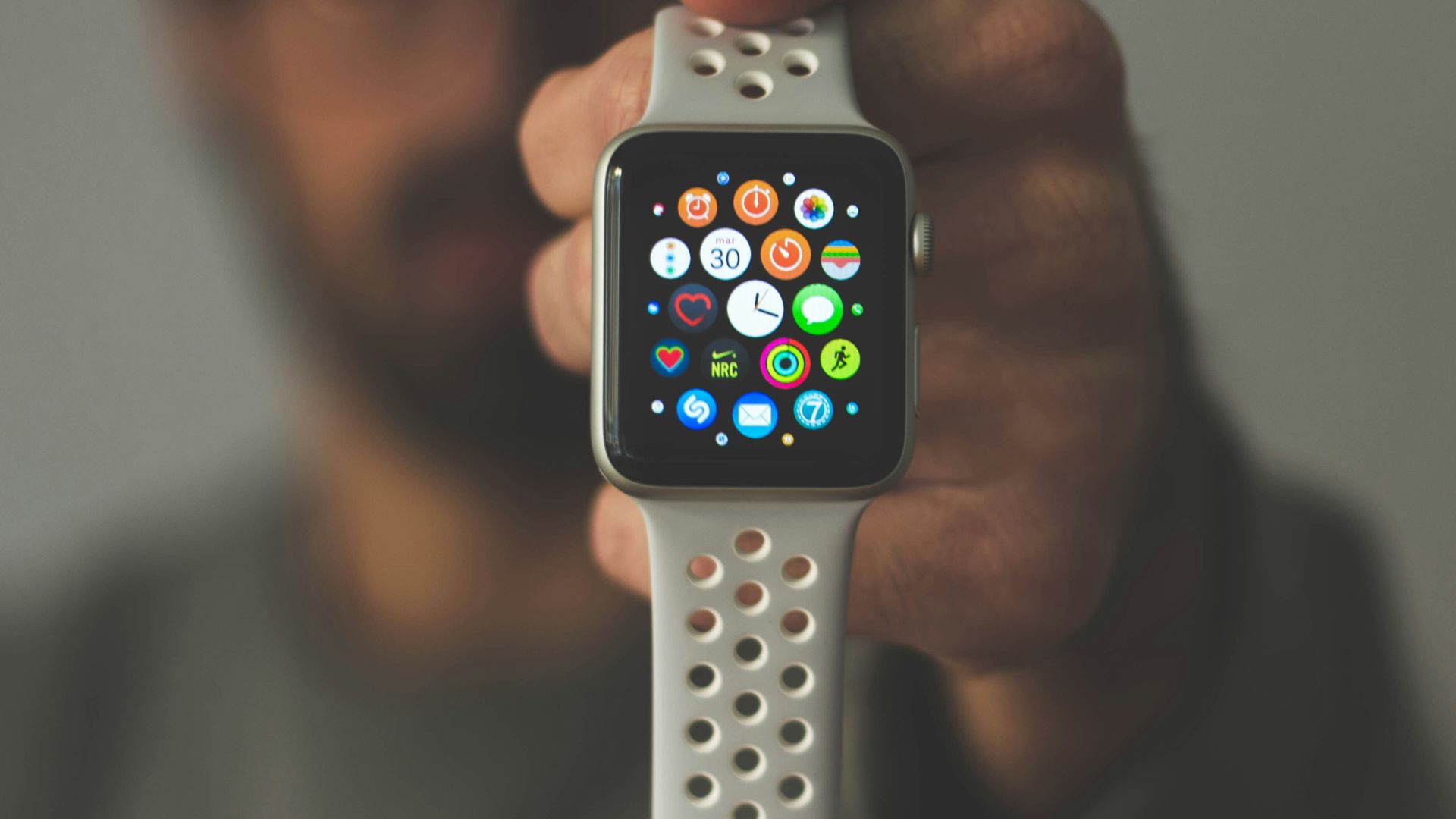 person holding silver aluminum case Apple Watch