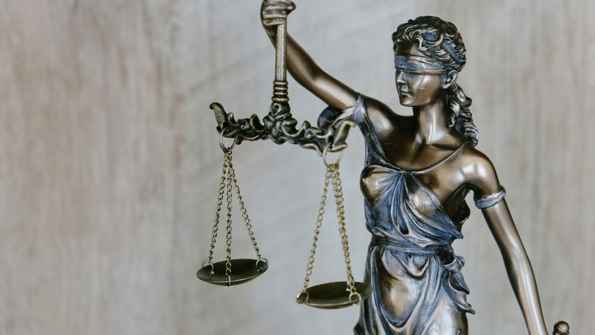 woman holding sword statue during daytime