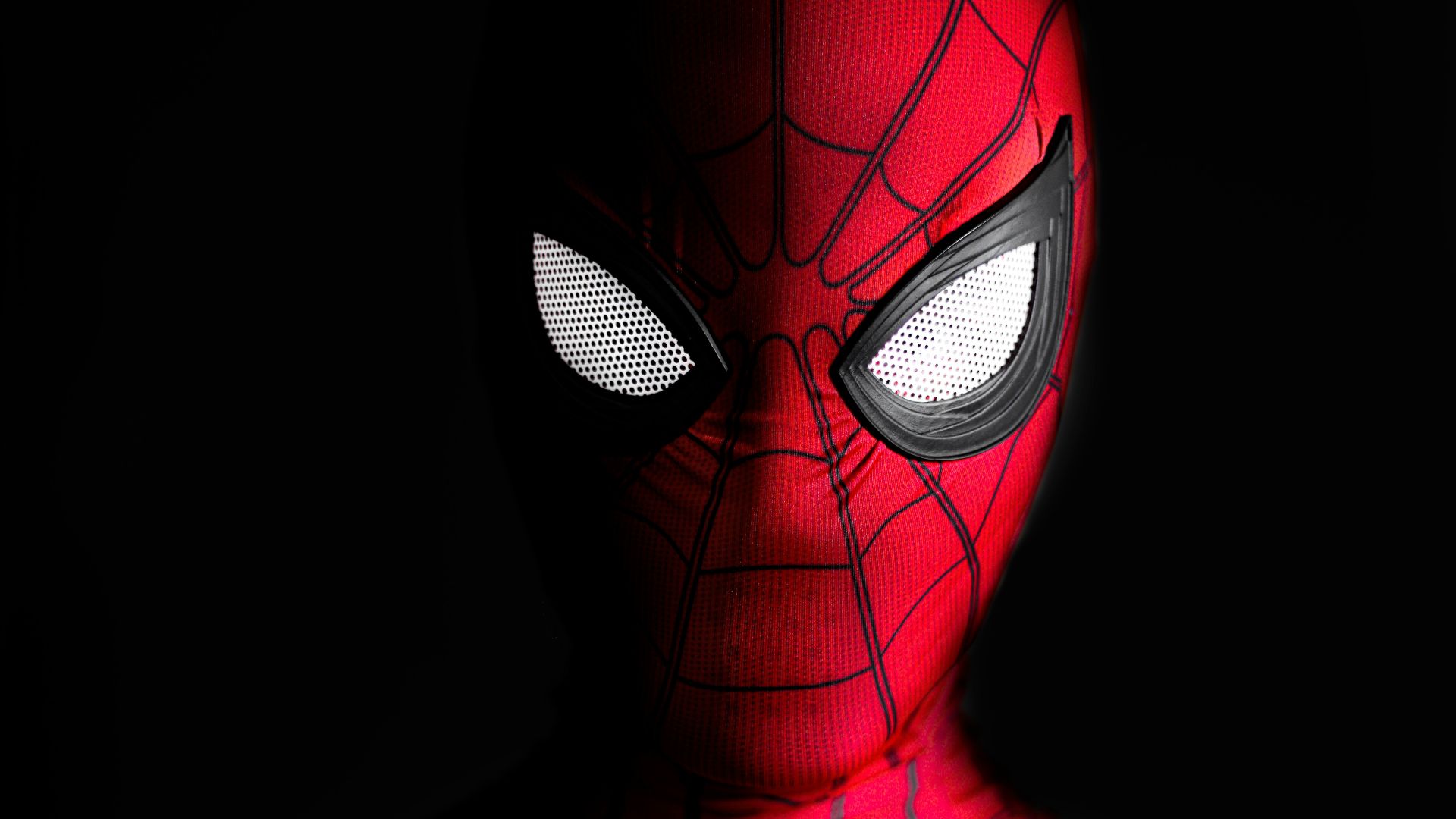 a close up of a spider man with glowing eyes
