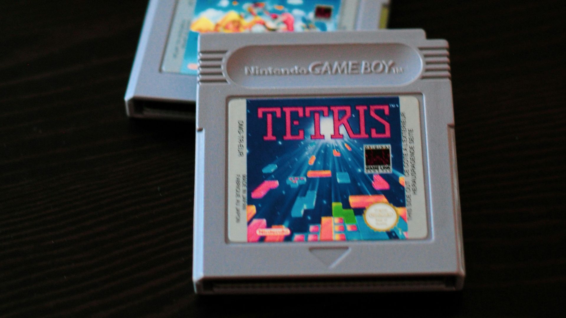 white Nintendo Game Boy controller and two cartridges