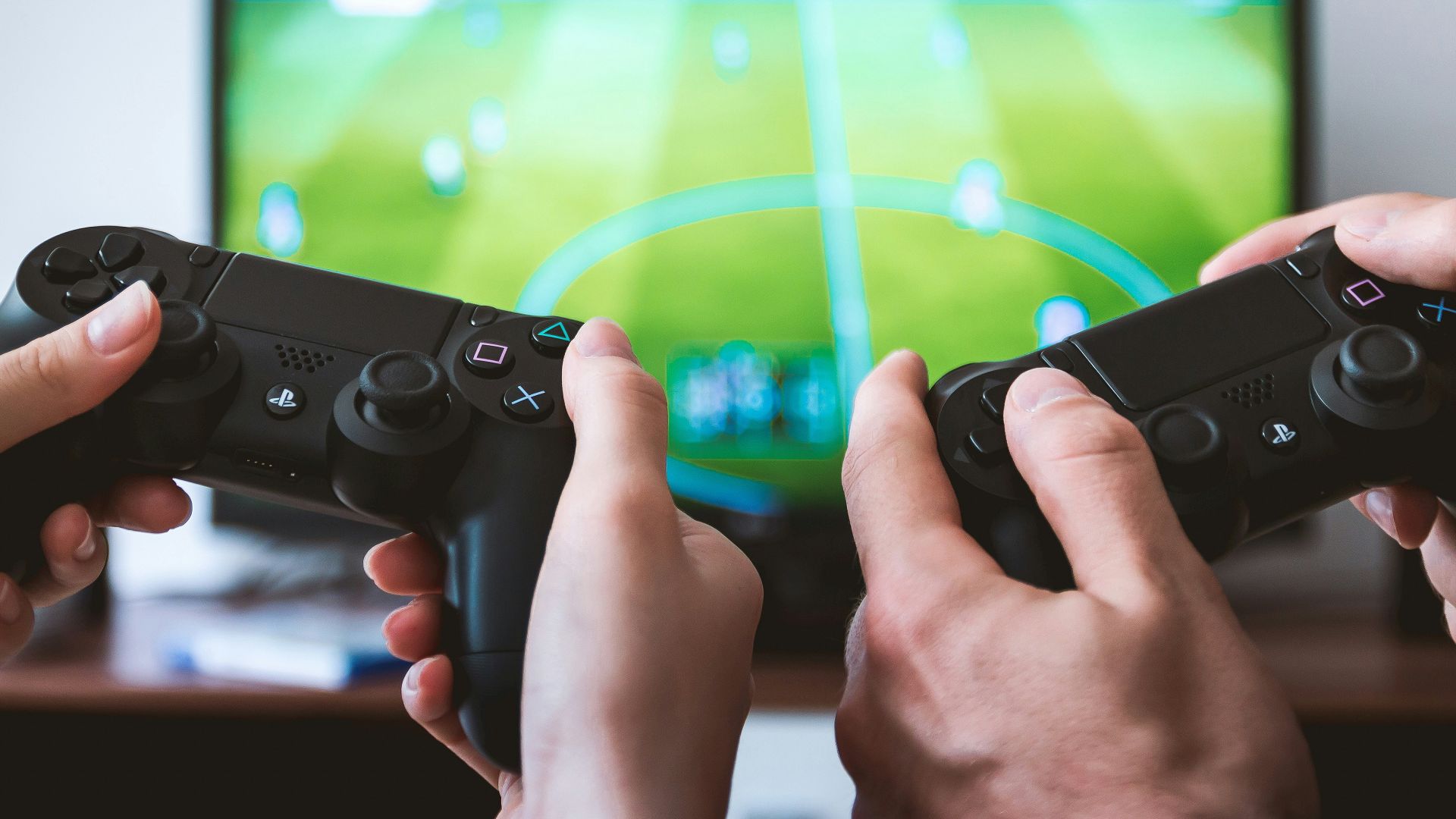 two people playing Sony PS4 game console