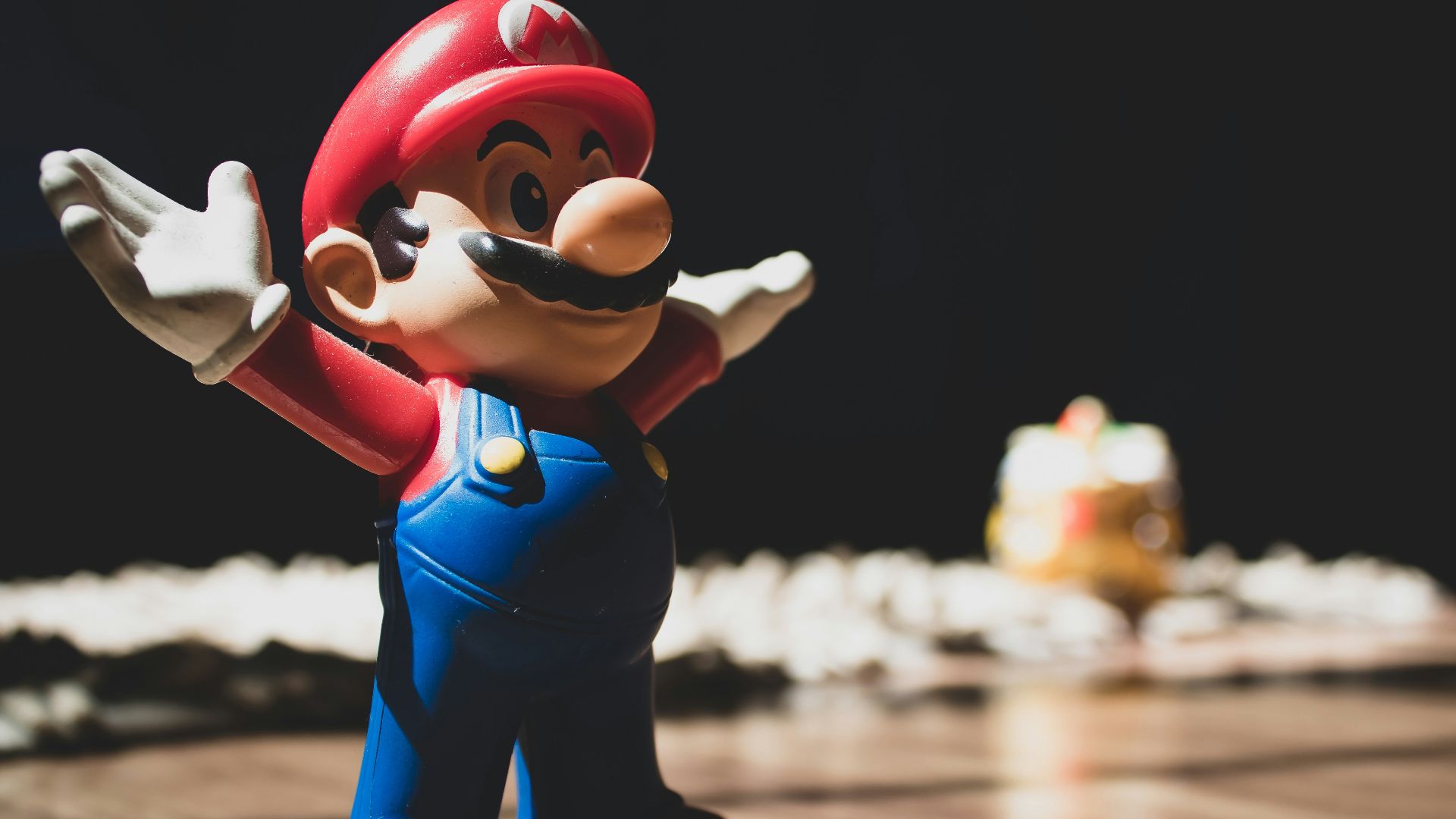 Super Mario figurine on brown surface