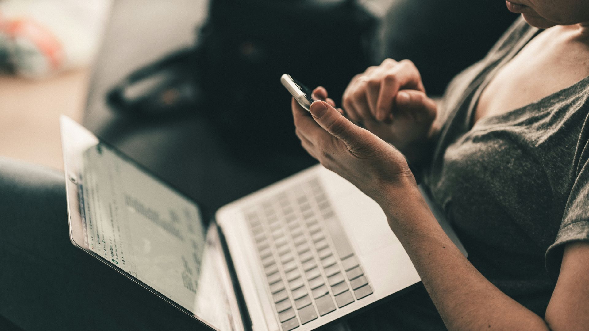 man in black shirt writing on white paper