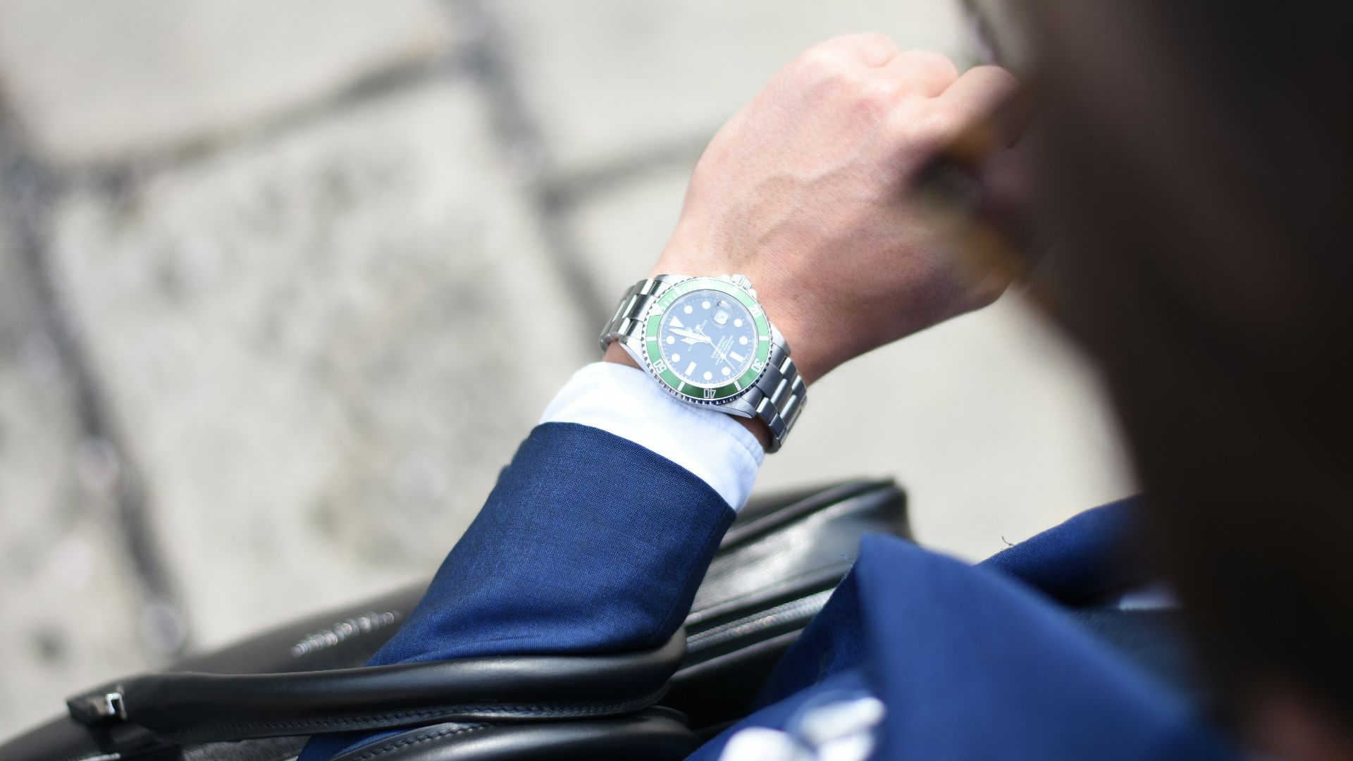 person looking at silver-colored analog watch